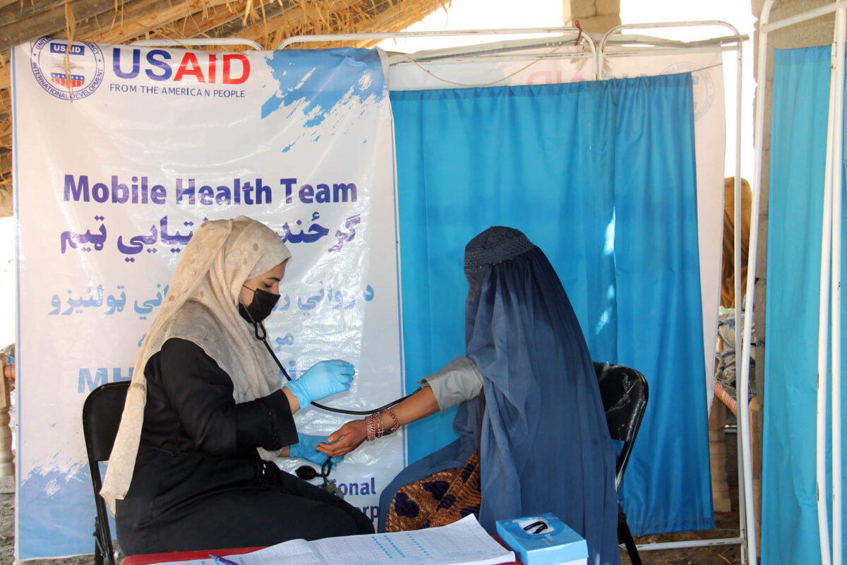 A midwife with an International Medical Corps mobile team in Afghanistan examines a patient in a remote village.