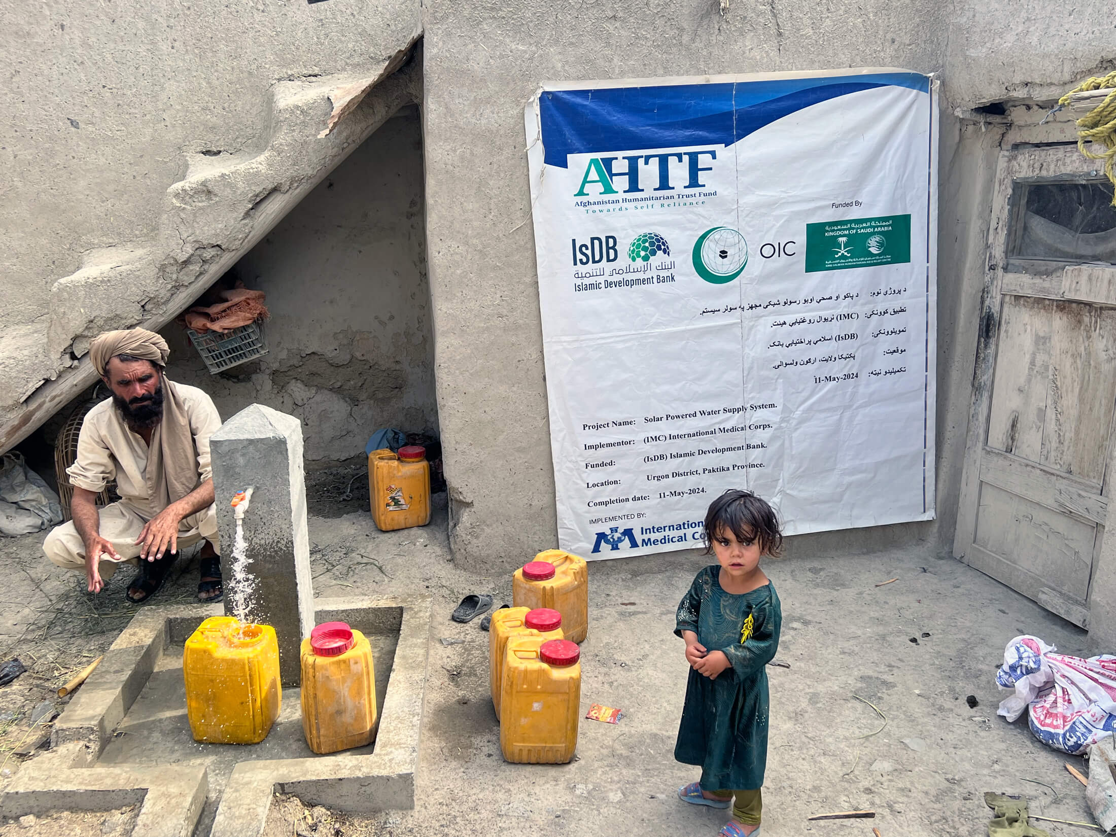 AFGH_Picture---1 Families collect water from a water tab built by our teams.