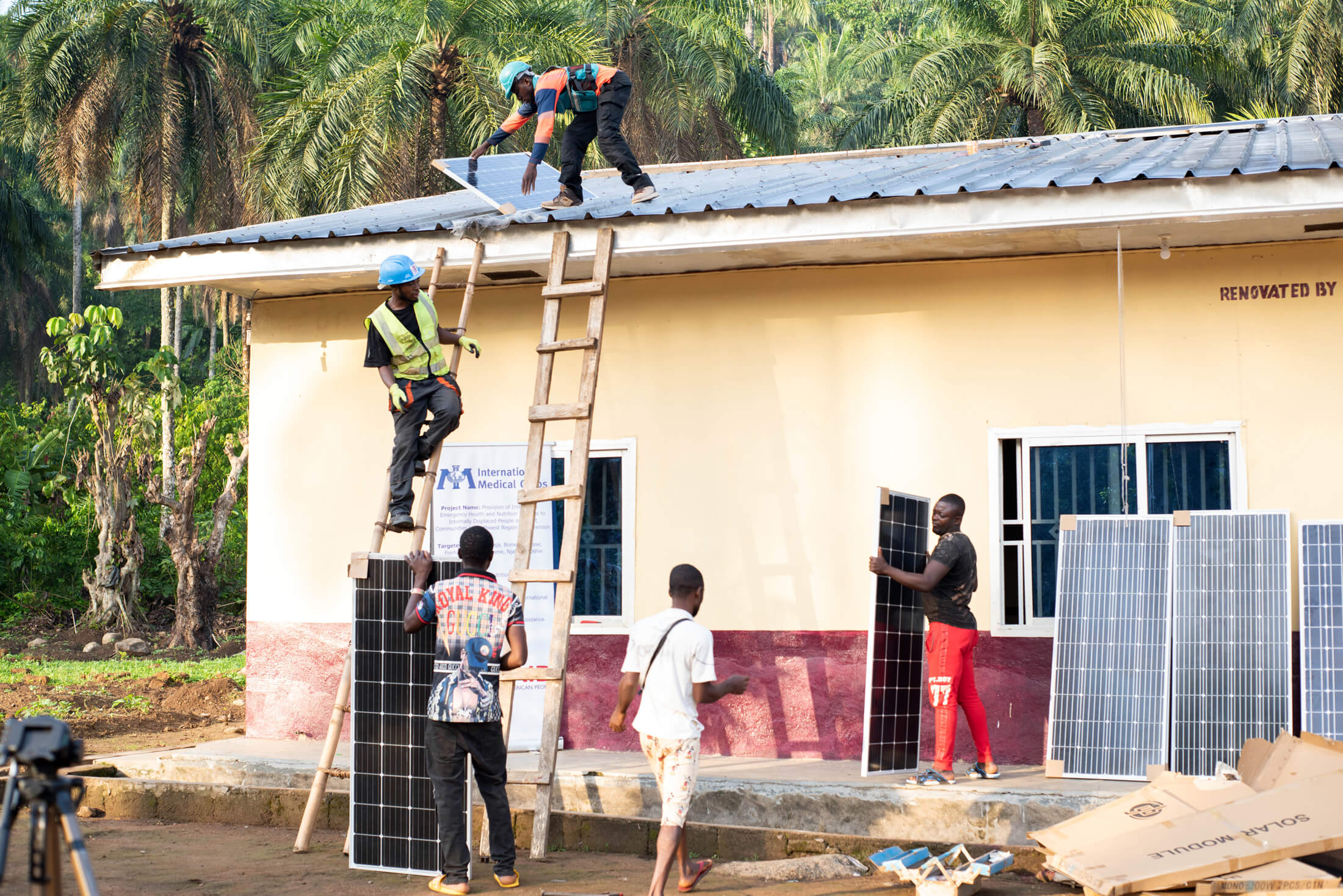 CAM_DSC_2837 Workers install solar panels on the roof of the Akwaja Integrated Health Center.