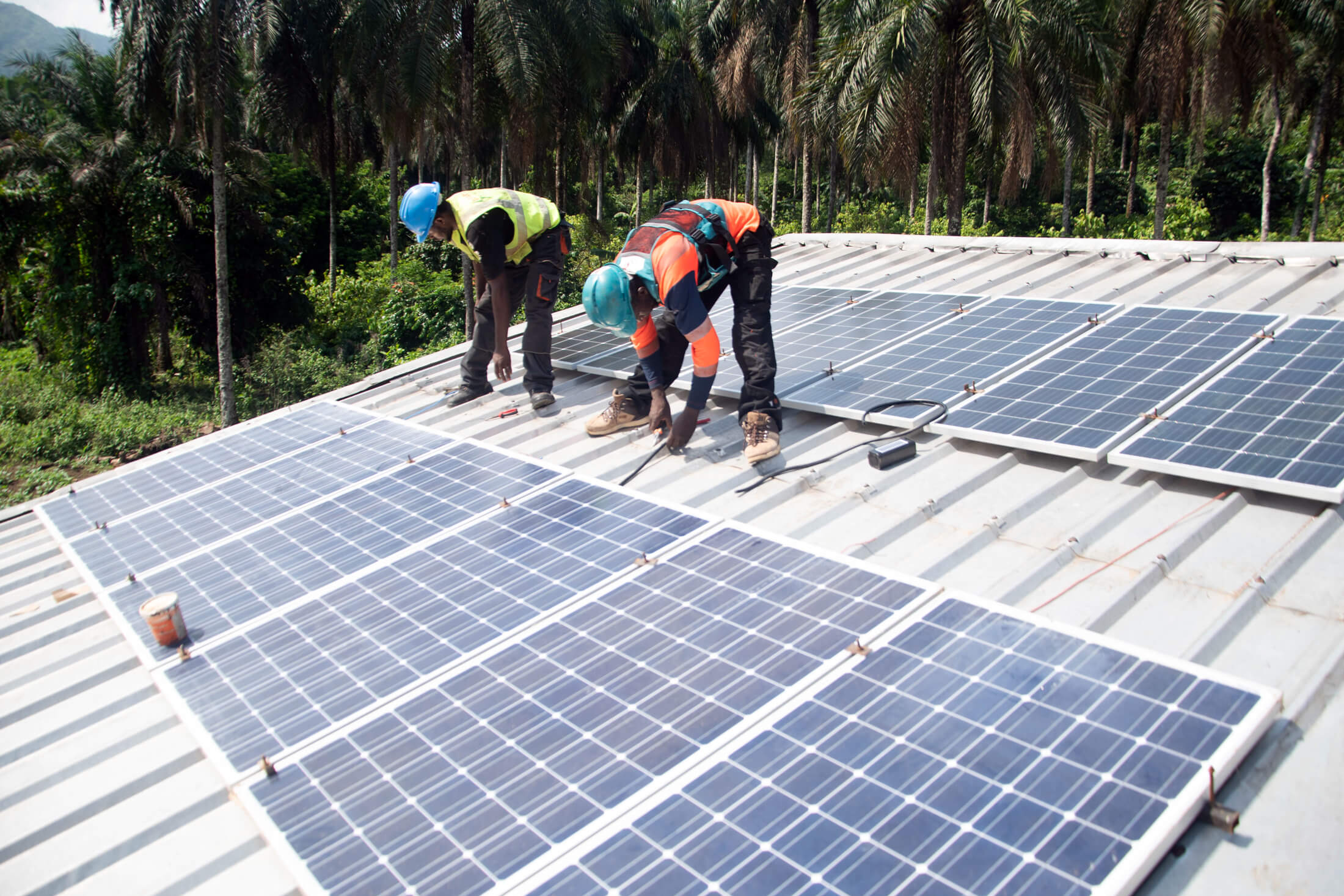CAM_DSC_2879 Workers install solar panels on the roof of the Akwaja Integrated Health Center.
