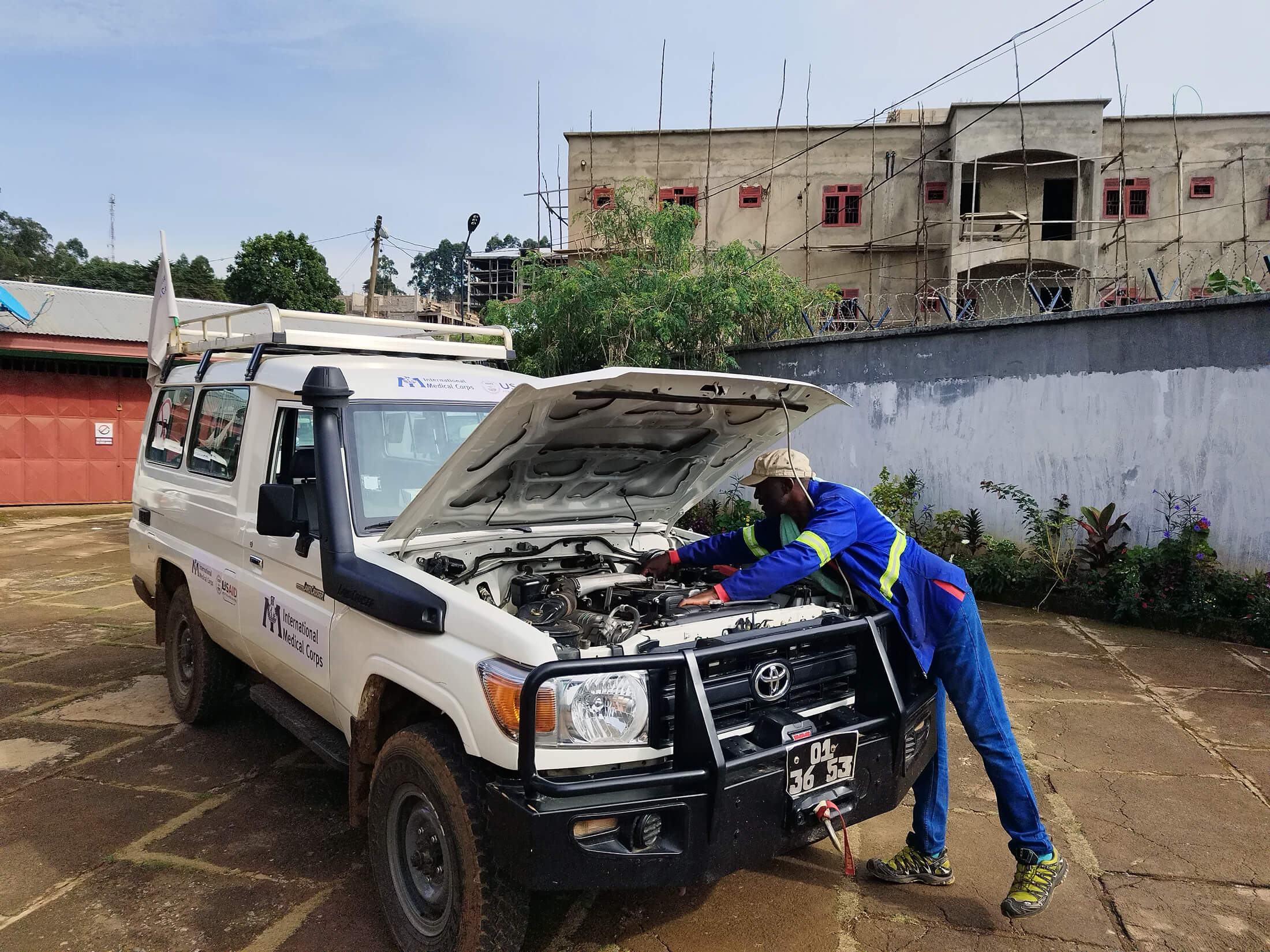 CAM_V23 Vincent Ndi checks under the hood of his vehicle.