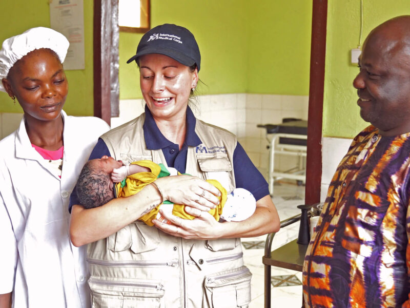 International Medical Corps staff and a Bria Annex Institute student gather around a newborn at the Bria Regional Teaching and Referral Hospital.