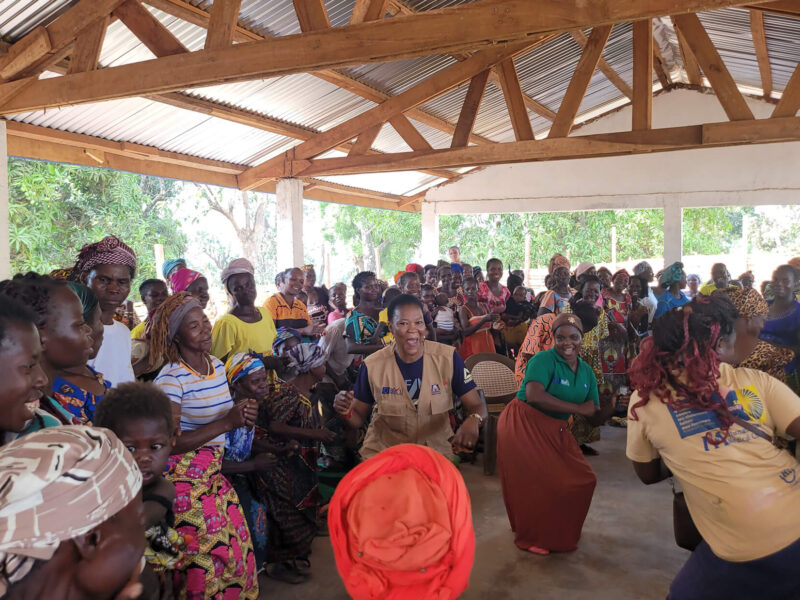 Bedi Bienvenue, center, dances with local women after a discussion about their roles and responsibilities in the community.