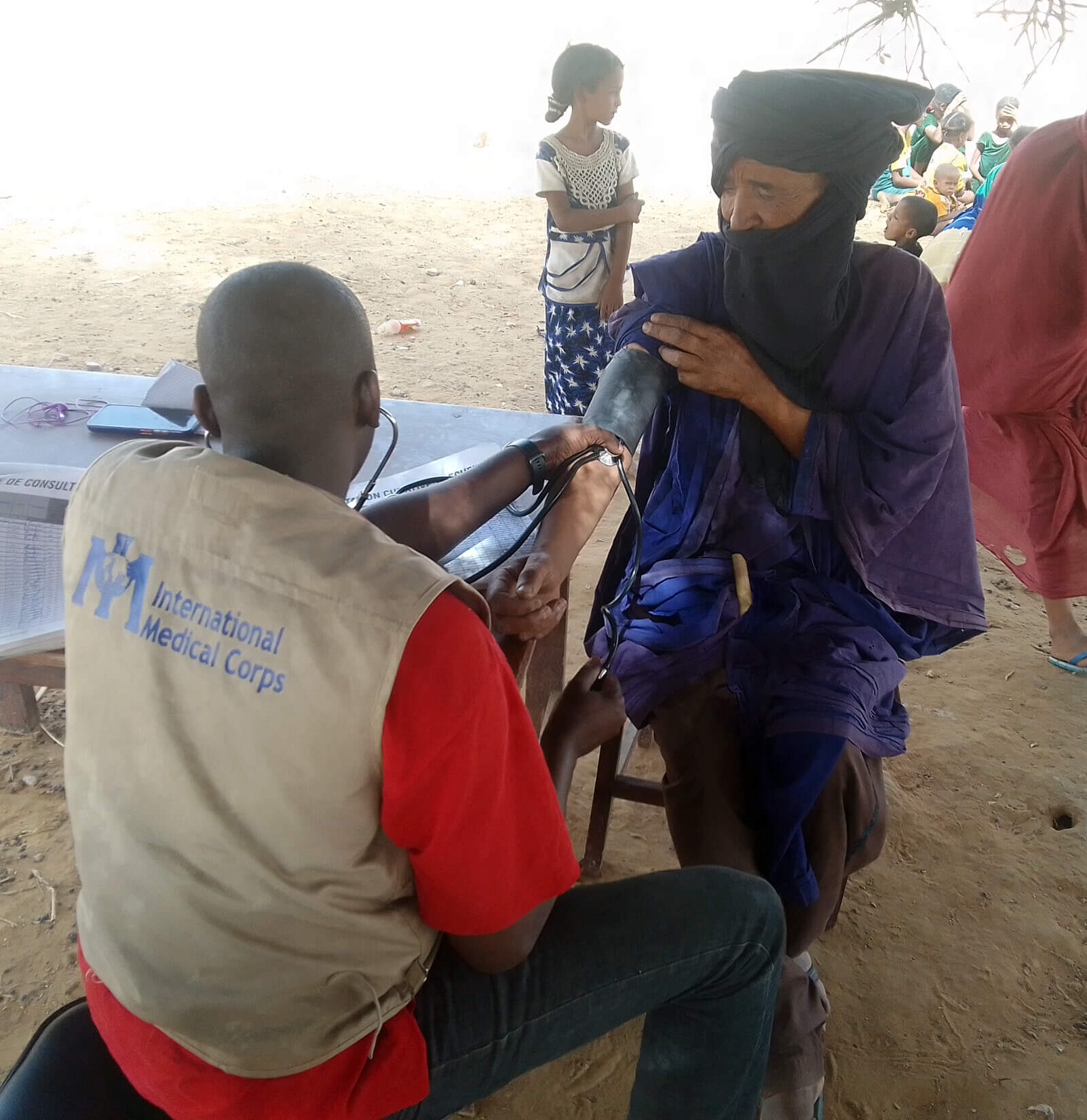 Curative-consultation_Dr-Landoure-Ibrahima,-Timbuktu-MMU-Medical-Doctor Dr. Landoure Ibrahima, working with the Timbuktu MMU, gives a patient a curative consultation.