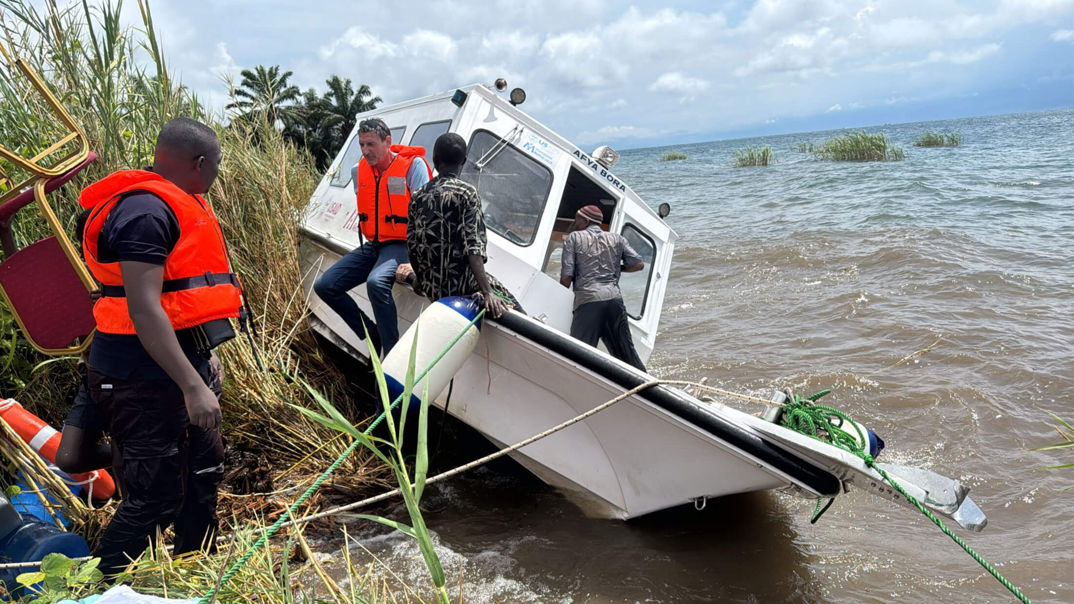 DRC_IMG_2728292 While on a mission to deliver supplies and medicines to displaced people and host communities in eastern DRC, International Medical Corps logistics staff quickly disembarked from a speedboat after harsh waves caused them to initiate an emergency docking due to safety concerns.