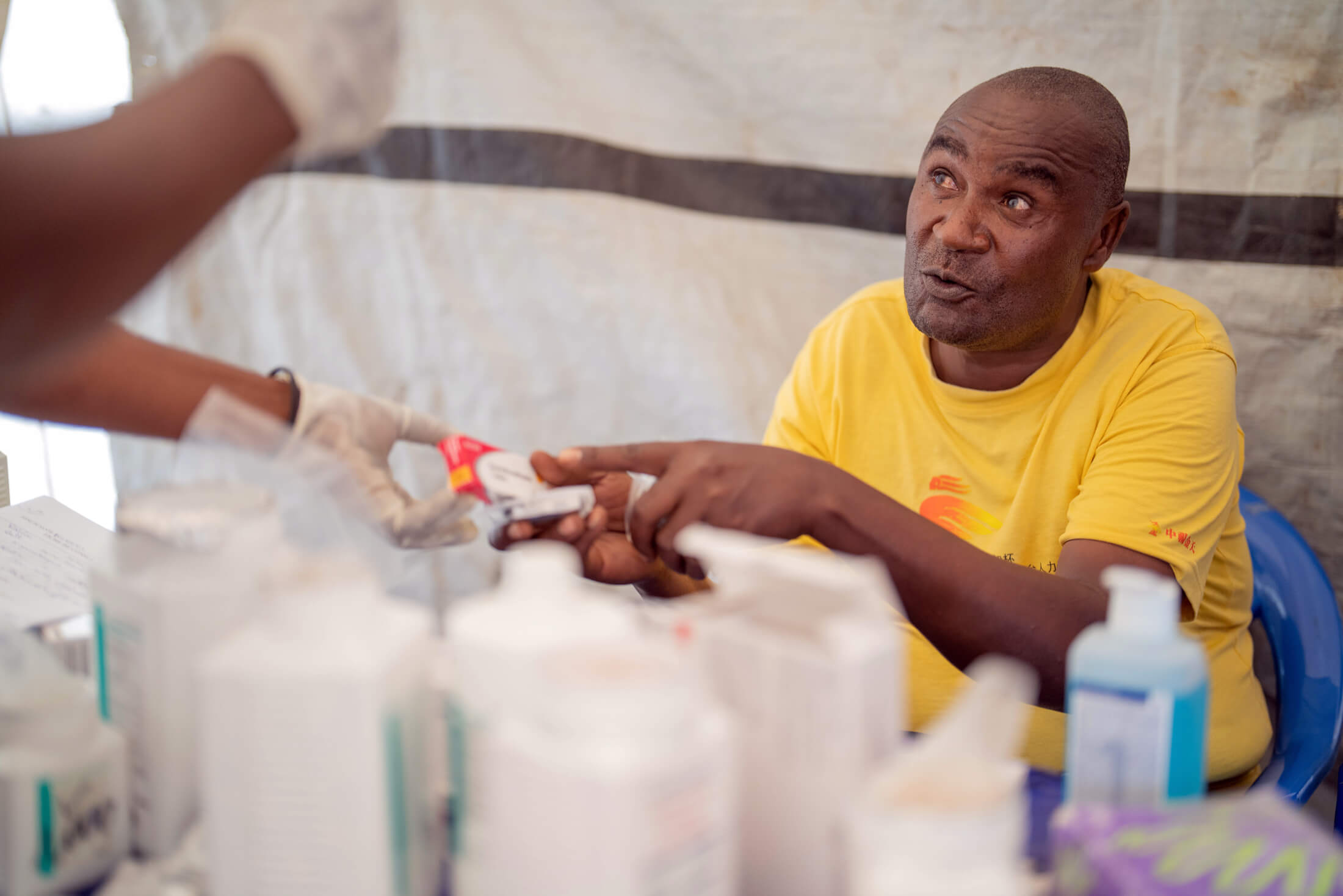 Kabiona, who fled the violence in Bweremana, receives medication during a consultation at the Matendo IDP site.