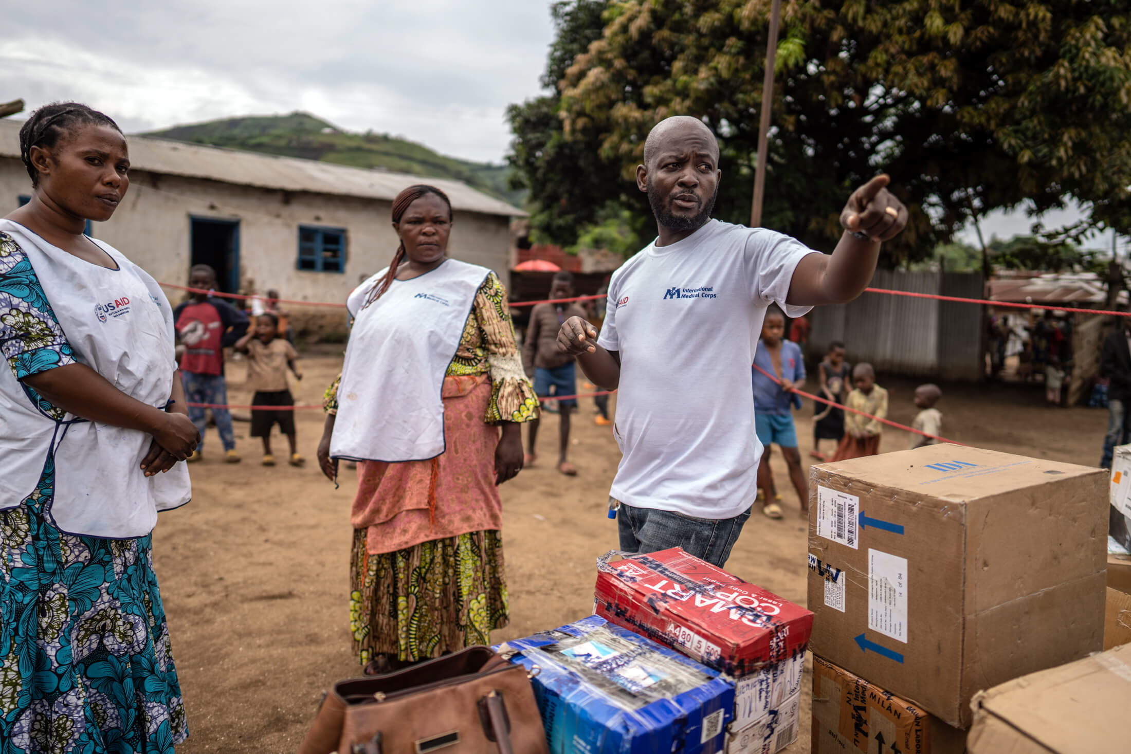 Before the MMU begins treating IDPs and host community members, Bienvenu Musangu, Program Manager (right), briefs Salama Fumbu (center) and Cibalonza Rachelle, two community health workers (CHWs).