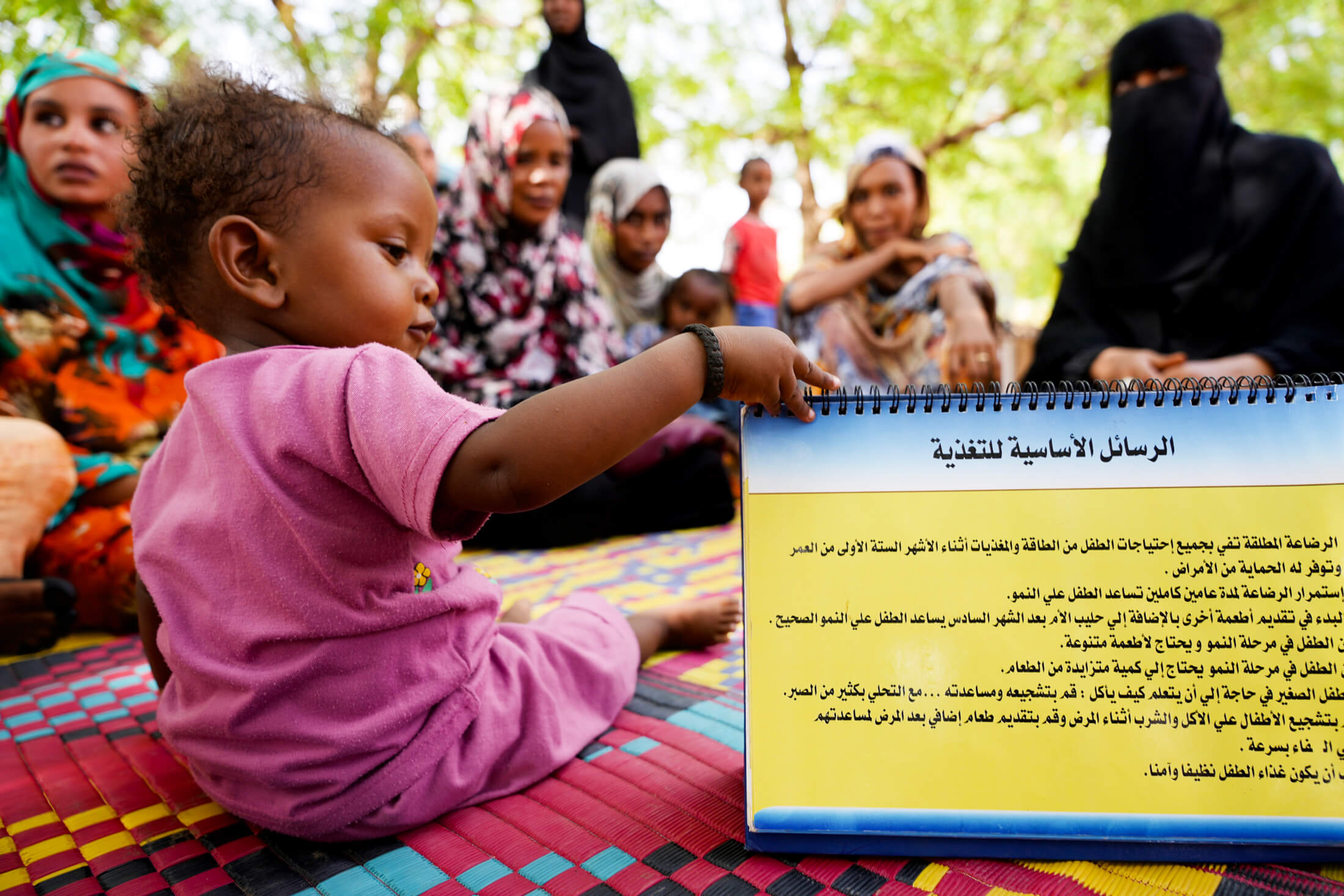 DSC05214 Ashgan looks at the breastfeeding manual that was passed around the group to share the essential tips for nurturing your baby through balanced nutrition. For the mothers’ benefit, the text is in both Arabic and English.