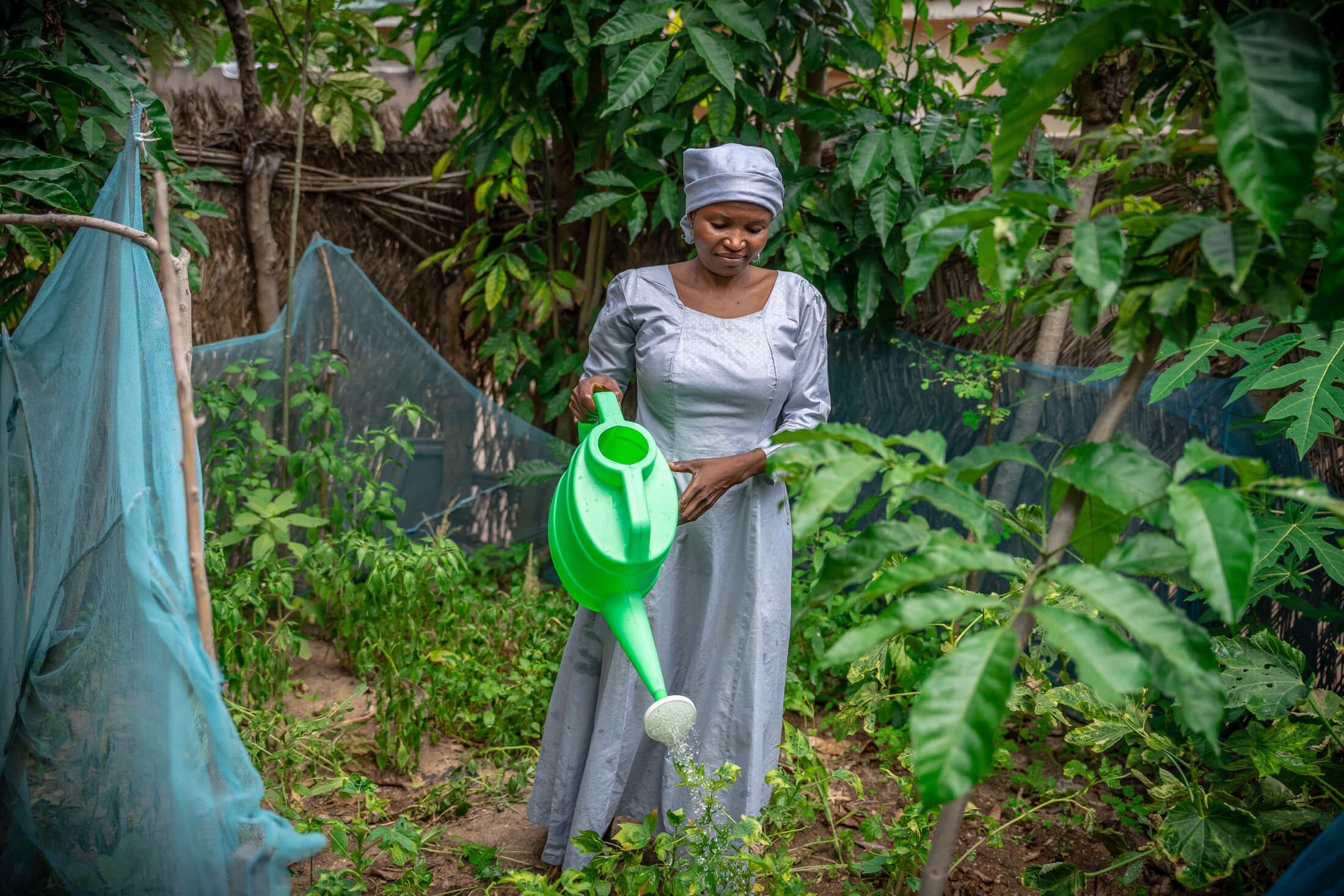 ETH_EKPU_IMC_SHANI_070923_338 Elizabeth waters her garden.
