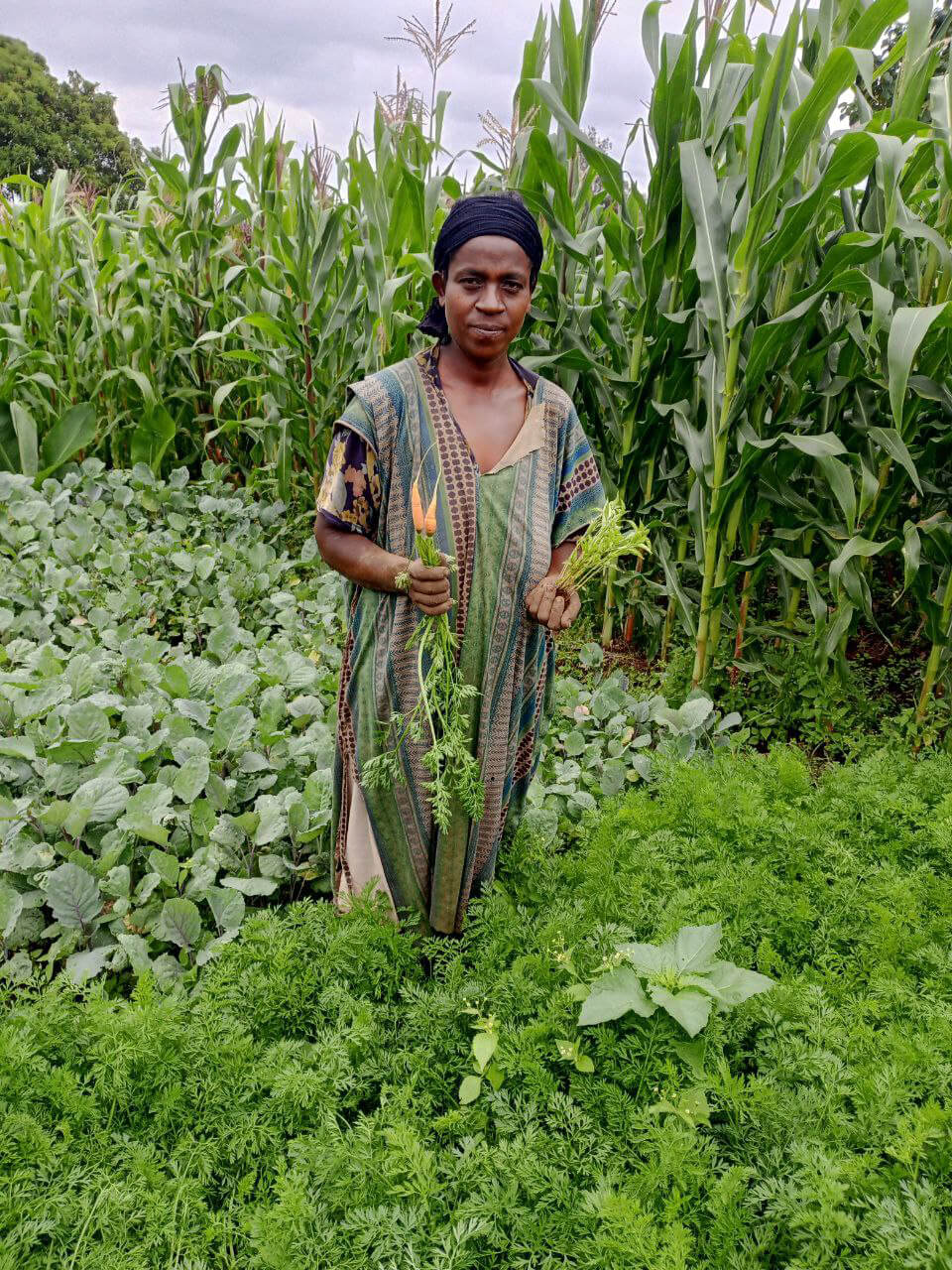 ETH_photo_2023-07-05_10-10-08 Abebech holds carrots that she harvested from her backyard garden.
