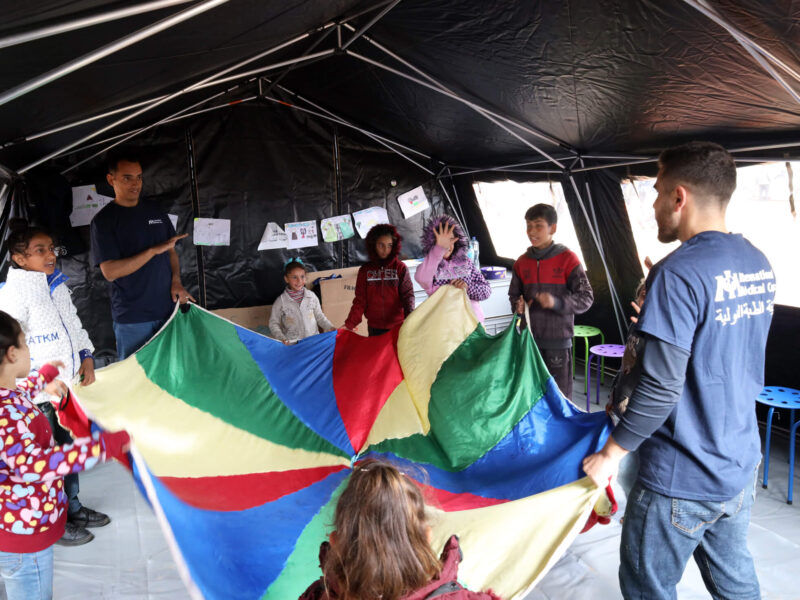 Child Protection specialists lead a play session at our field hospital.