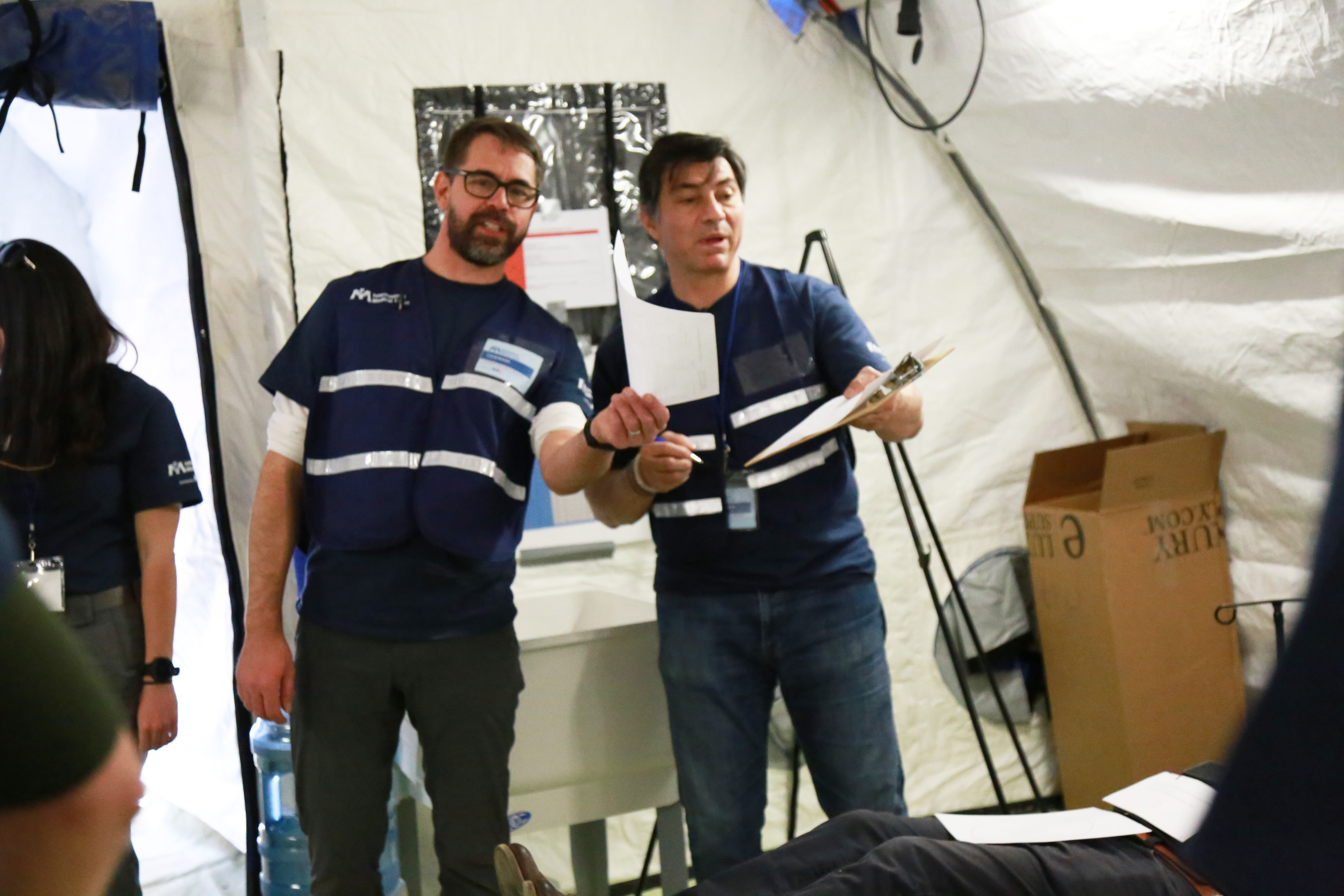 IMG_2728 copy Dr. Colin Bucks (L), Clinical Assistant Professor, Emergency Medicine, Stanford, and Dr. Hernando Garzon (R), Global Health Program Director, Kaiser Permanente, participate in the field hospital simulation.