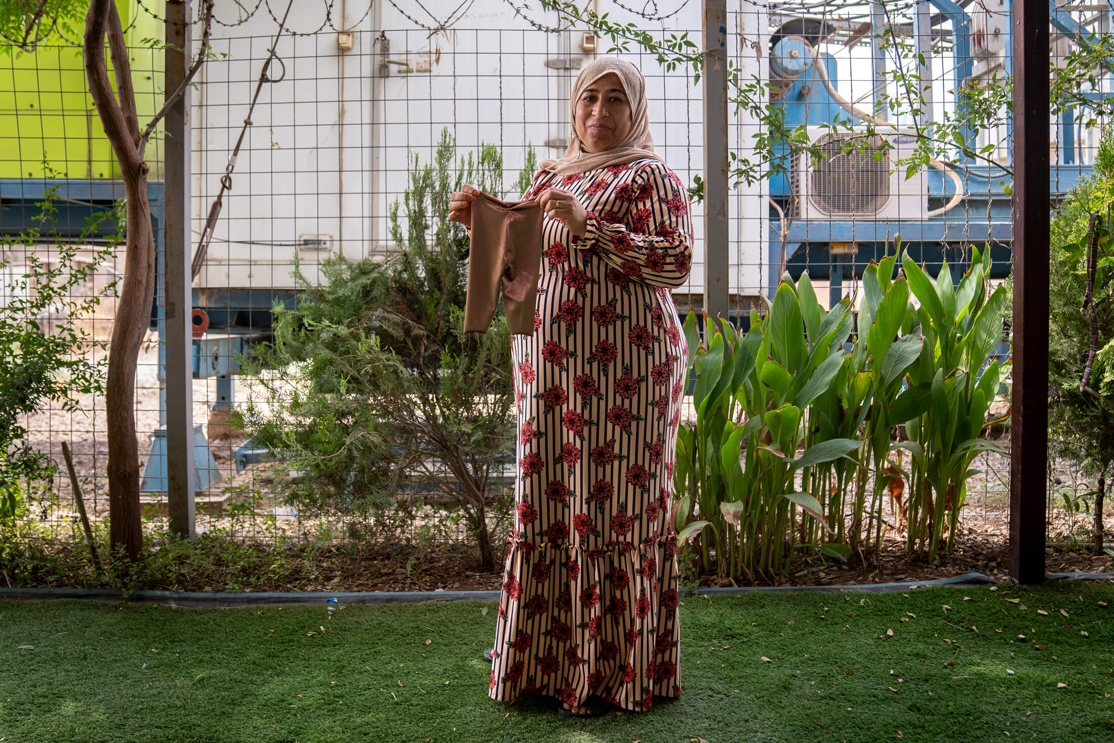 IRAQ_Diana-Zeyneb-Alhindawi_20230829-DZA09200-Diana-Alhindawi Mahsoma displays an article of clothing she tailored in Iraq.