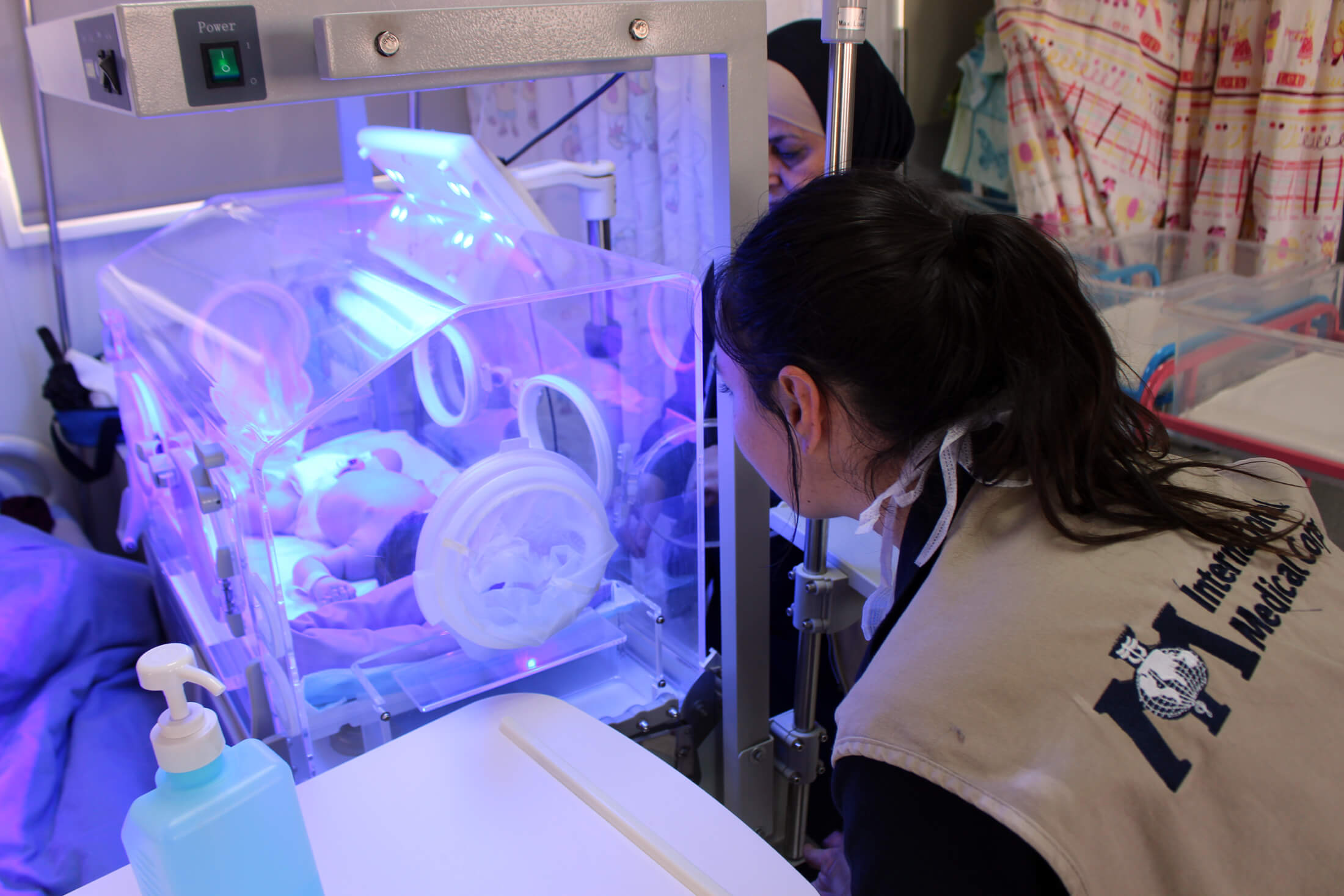 JORD_C_IMG_0271 A nurse checks on a newborn baby in an incubator.