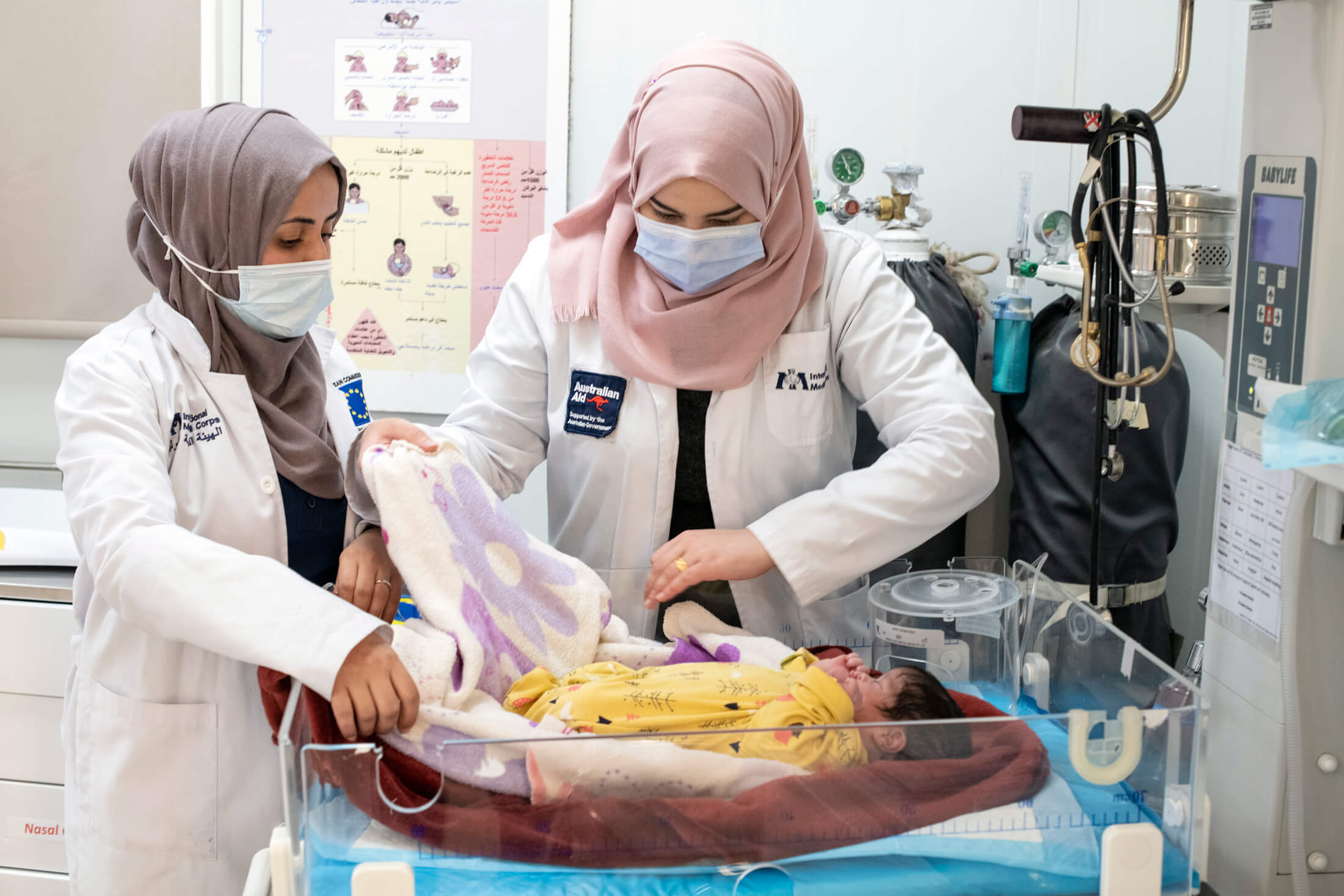 JORD_C_NBseiso__125 Nurses Ghadeer Abu Mel'a and Rawan Al Eisi swaddle a newborn baby in the hospital’s maternity ward.
