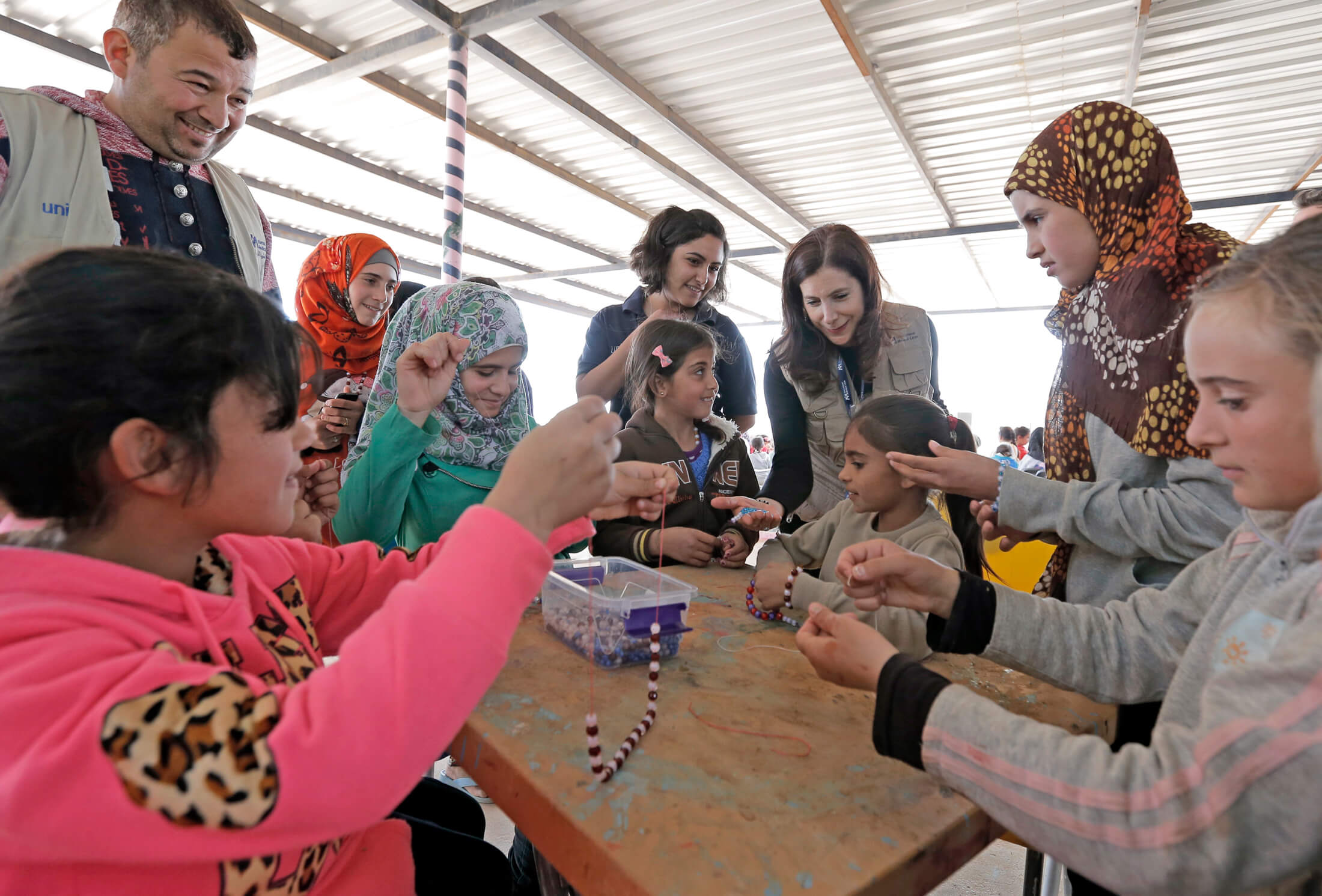 JORD_D__E8P3863 International Medical Corps President and CEO Nancy Aossey joins a children’s craft session during her visit to the camp in 2016.