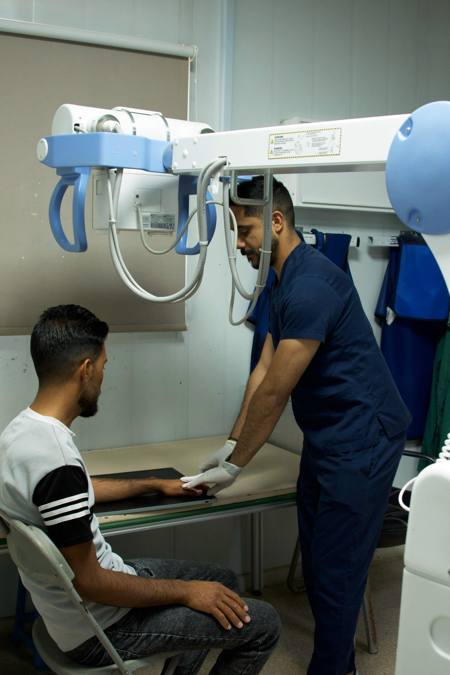 JORD_DSC8816 At Azraq refugee camp, a health worker conducts diagnostic services for a resident.