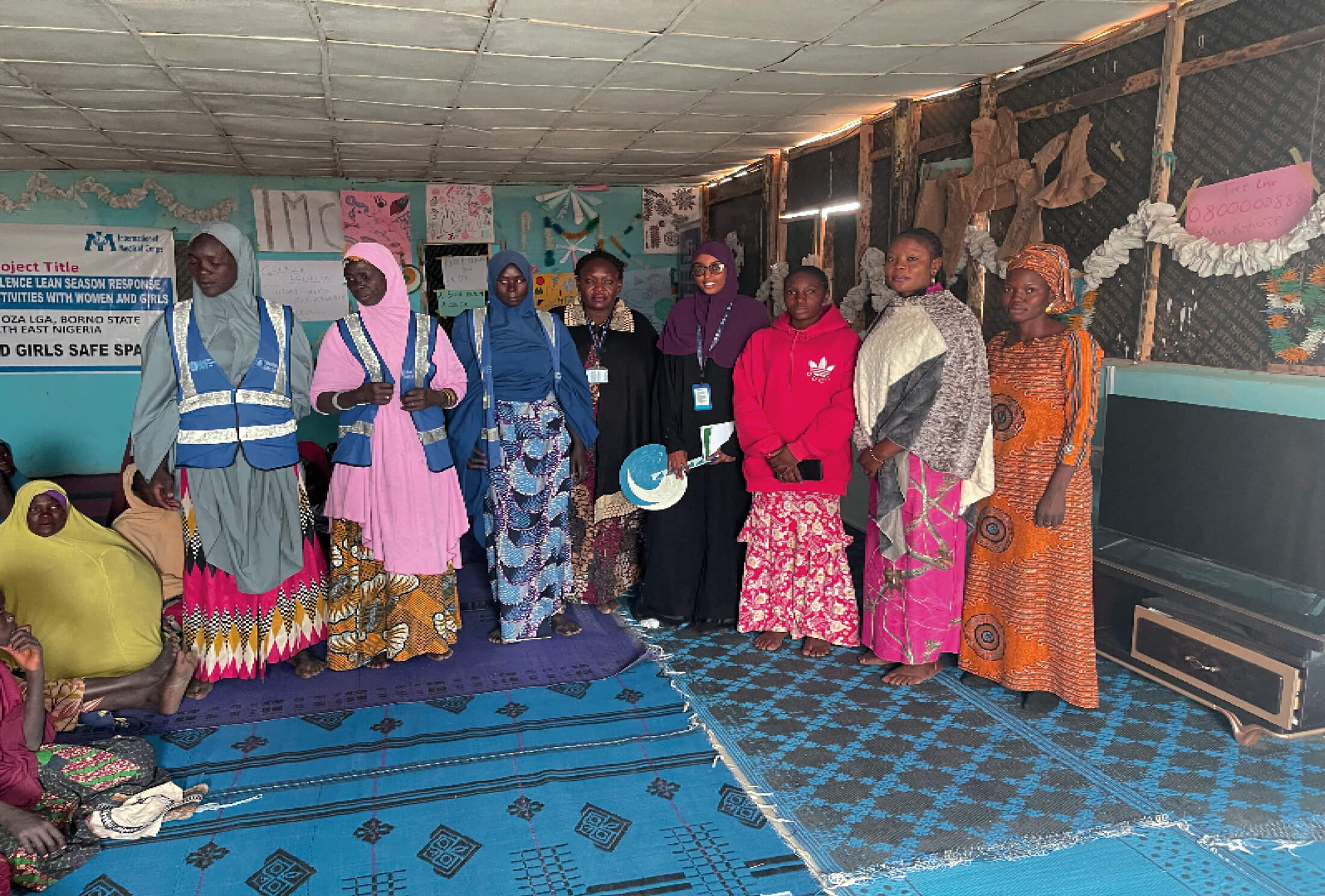 NIGERIA_Photo-4 Somalia GBV Coordinator Hiba Hassan Ahmed (fourth from right) is shown with International Medical Corps Nigeria staff members, community volunteers and beneficiaries at the Ndaware women’s and girls’ safe space in Pulka, Nigeria.