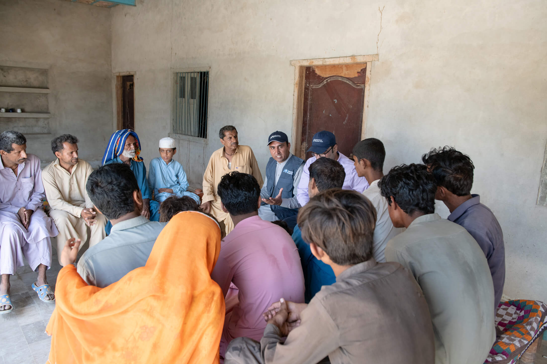 Burhan Ullah, WASH Coordinator, meets with the local water management committee in Rindo Khan Laghari village. Water management committee members are trained to maintain water supply systems, so the systems don’t break down or malfunction over time.