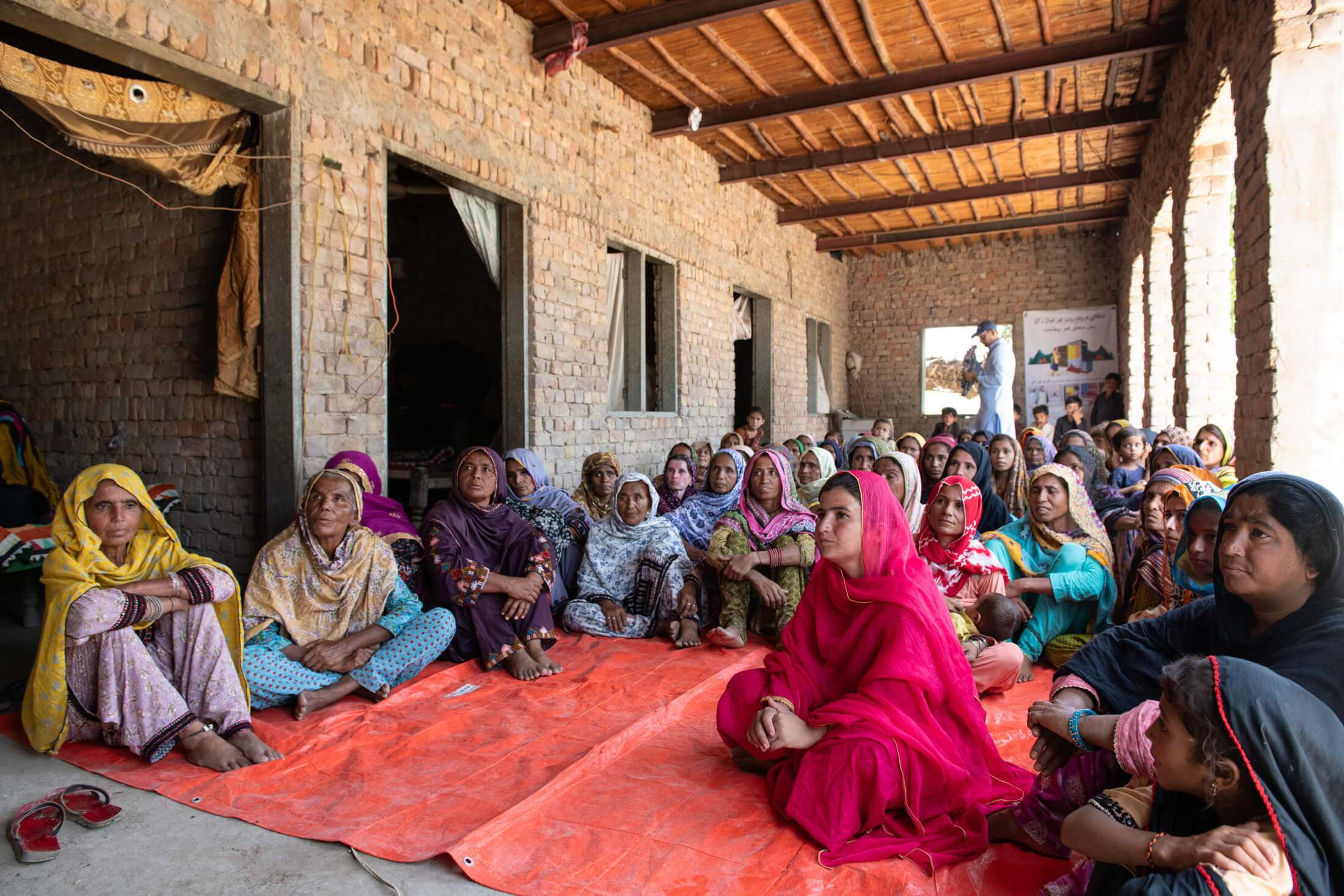 Women in Syed Waryal Shah A village listen intently as Irum Sattar shares important sanitation practices.