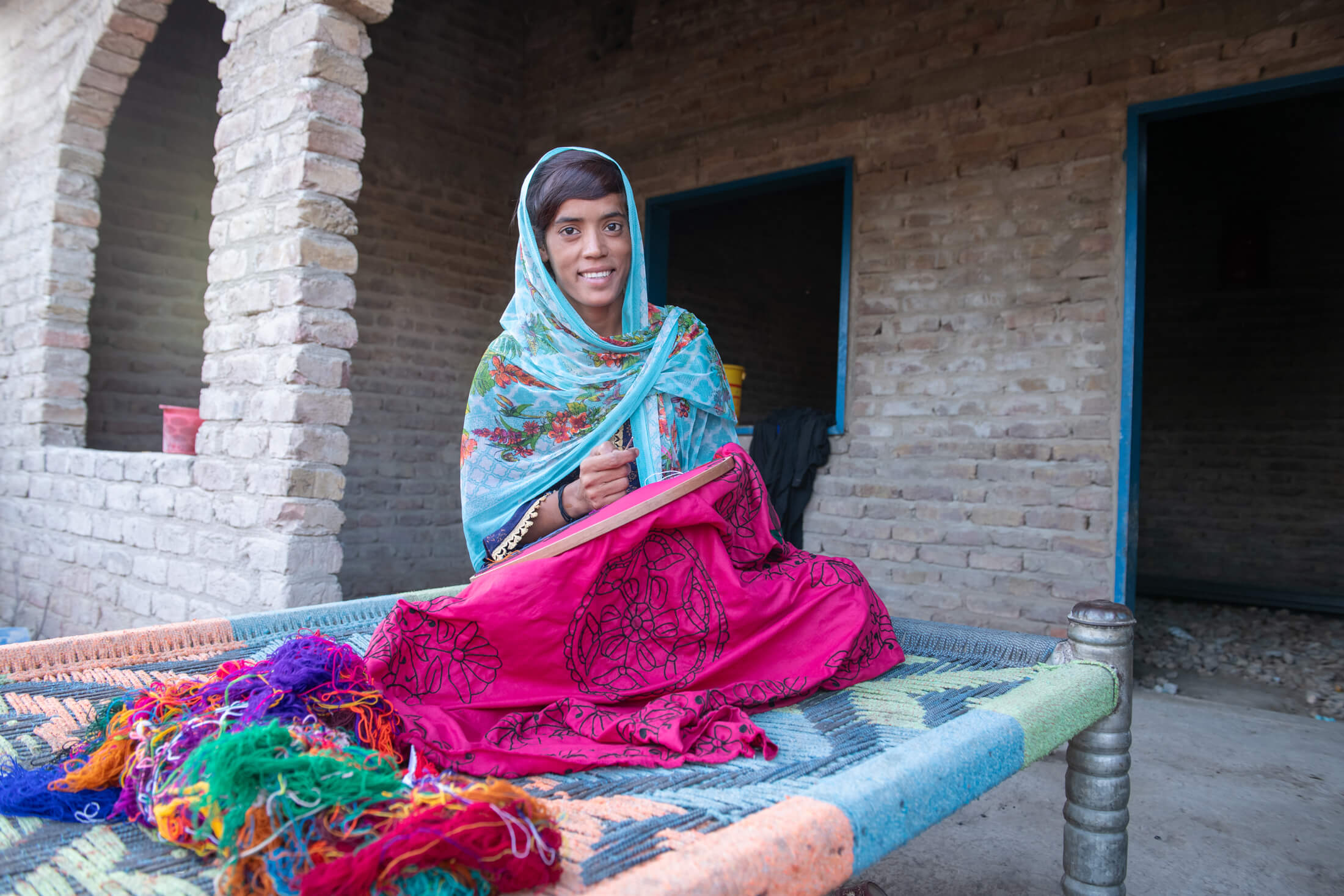 25-year-old Shamma works on embroidery at her home in Ghuram Khan Brohi village. Before International Medical Corps repaired the water supply system there, Shamma had to travel long distances for water, leaving little to no time for embroidery—which meant she couldn’t earn an income for her family, causing significant financial hardship.