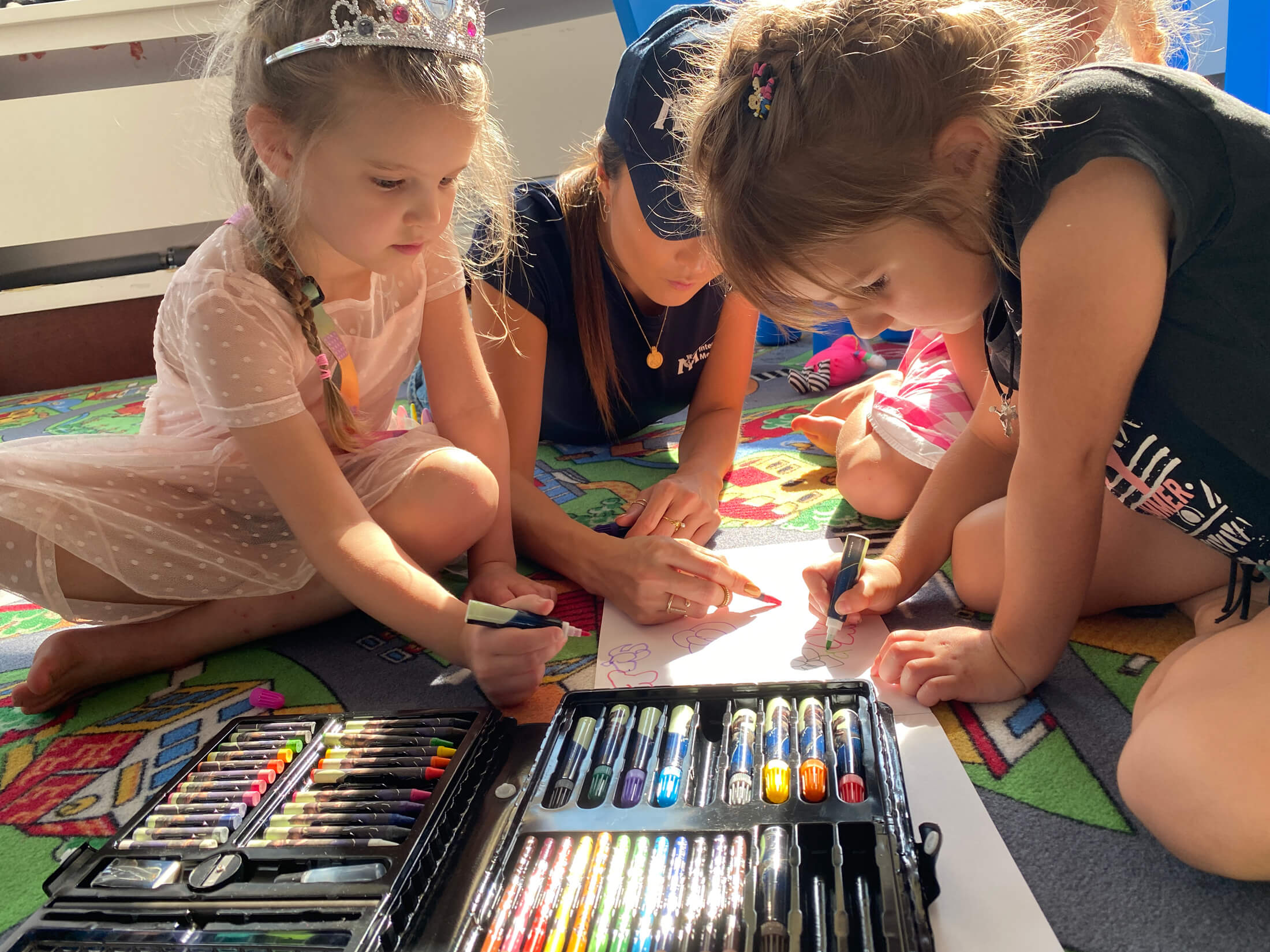 International Medical Corps Global Ambassador Ashley Park plays with children at a refugee center in Warsaw.