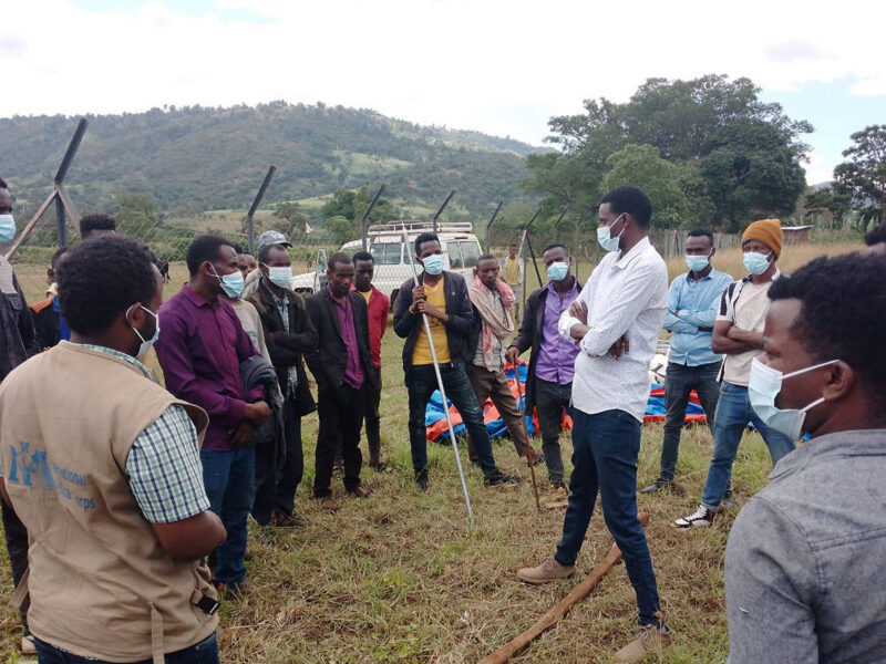 International Medical Corps staff members in Ethiopia run an awareness session on household water-treatment chemicals and distribute the chemicals to community households
