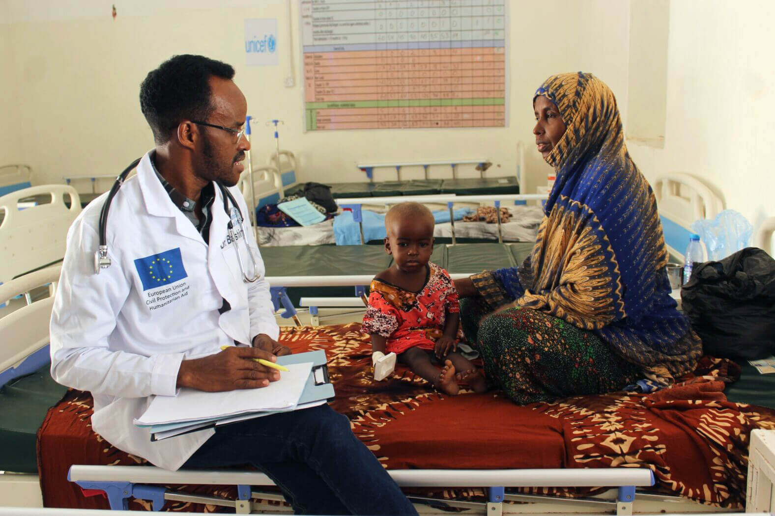 SOM_f9887bd7-8c78-4d8f-b3c9-aefa60e08aef An international Medical Corps doctor assesses a child for signs of malnutrition.