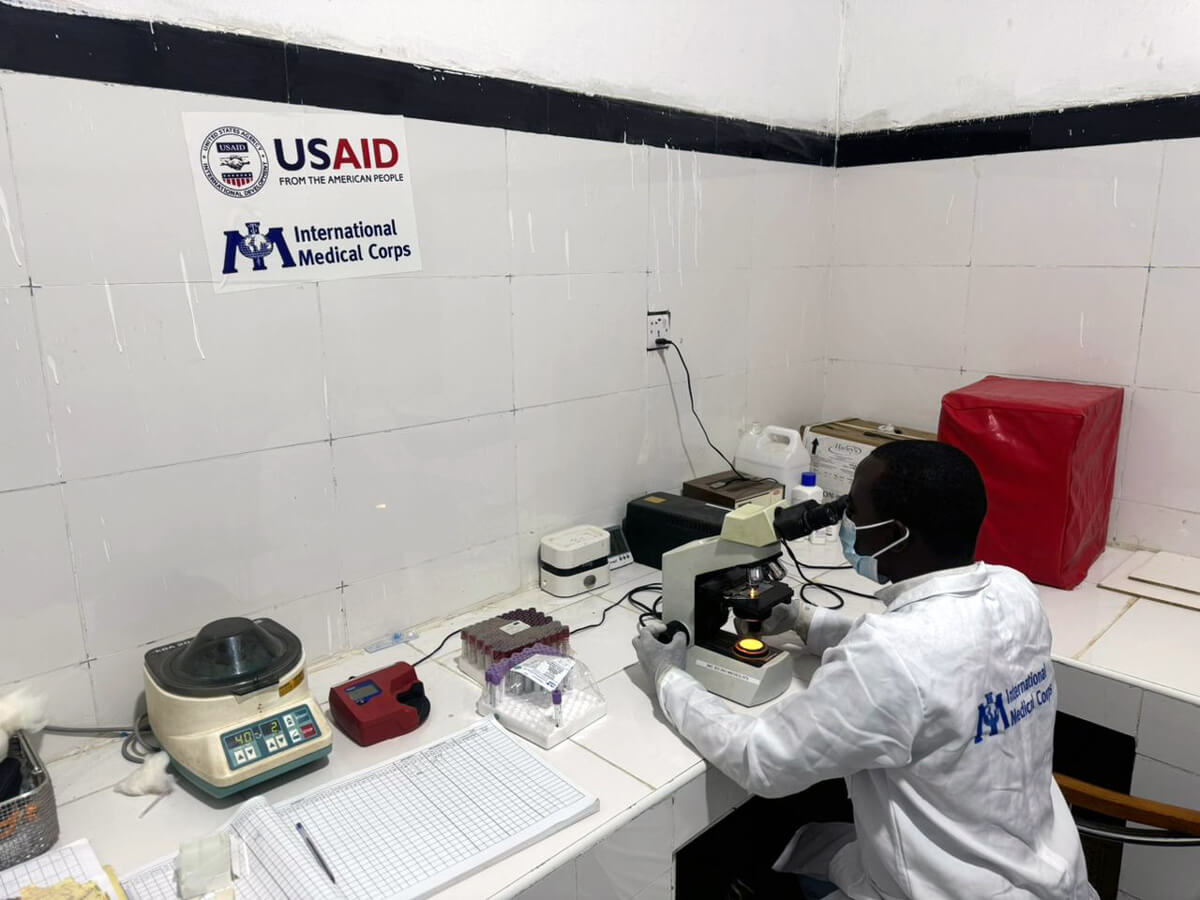 SOM_IMG-20240630-WA0027 Omar Abdirisaaq Aamir, Laboratory Technician at the JMU, looks for a malaria parasite using a microscope.