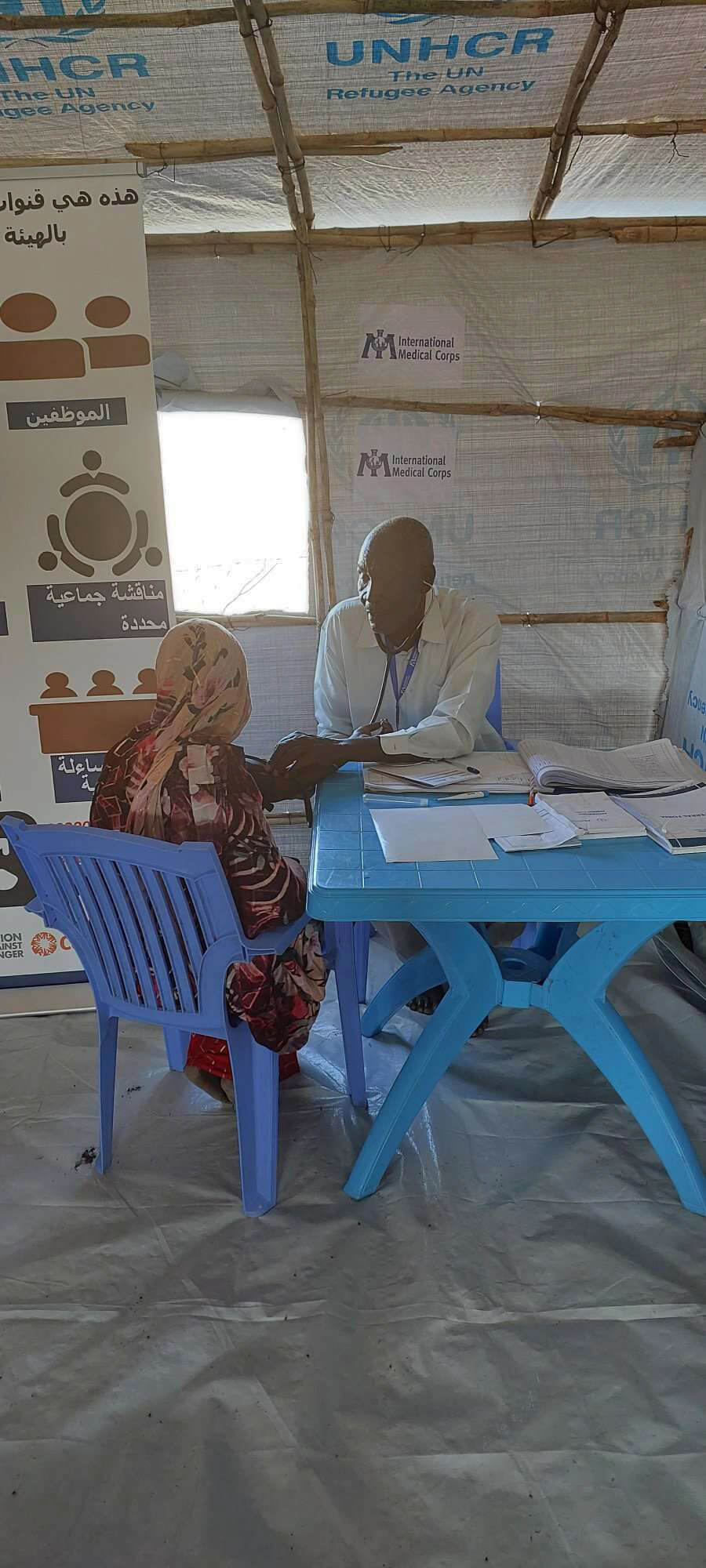 SOUTHSUDAN_Outpatient-Consultation-for-displaced-women-in-IMC-mobile-clinic A clinical officer provides a health consultation for a displaced woman in Renk, South Sudan.