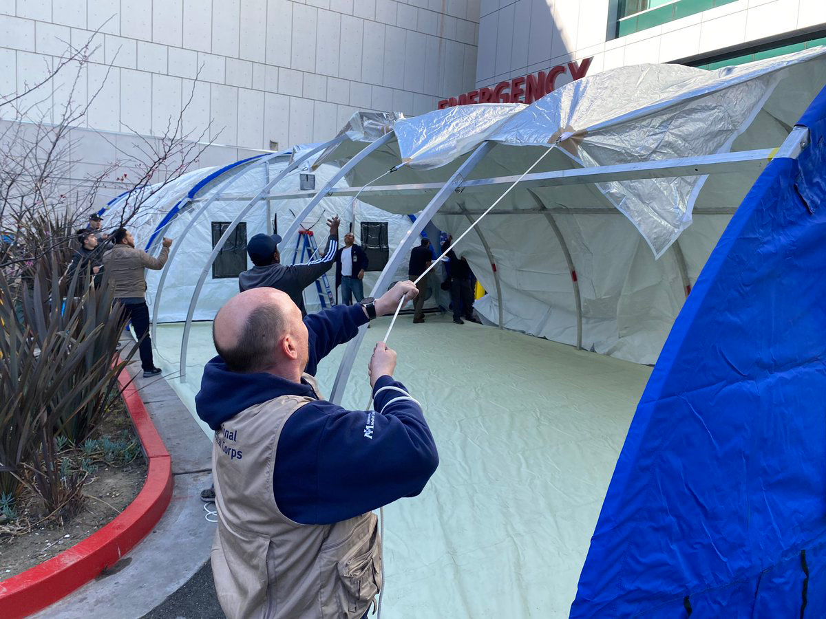 SSYIR2020_MLKCHsetup International Medical Corps staff members set up emergency shelters at the Martin Luther King, Jr. Hospital.