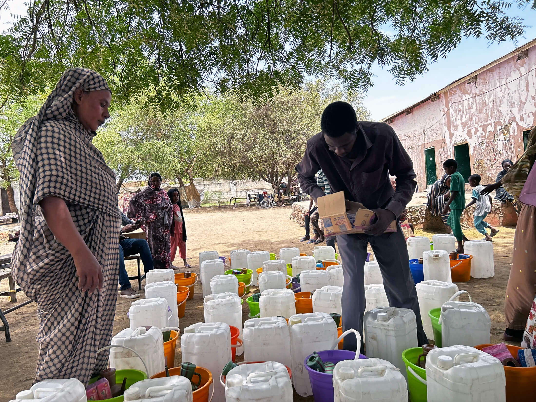 SUD_MG_6372 Staff members fill the hygiene kits with essential items.