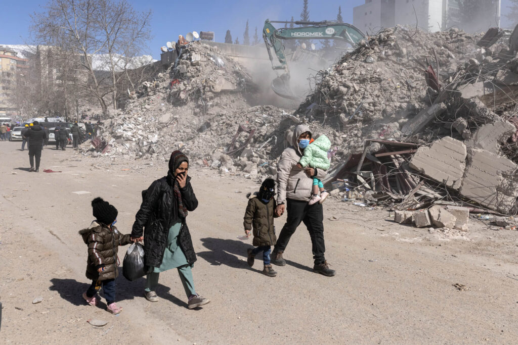 A displaced Turkish family seeks humanitarian aid distributions in Kahramanmaras, Turkey.