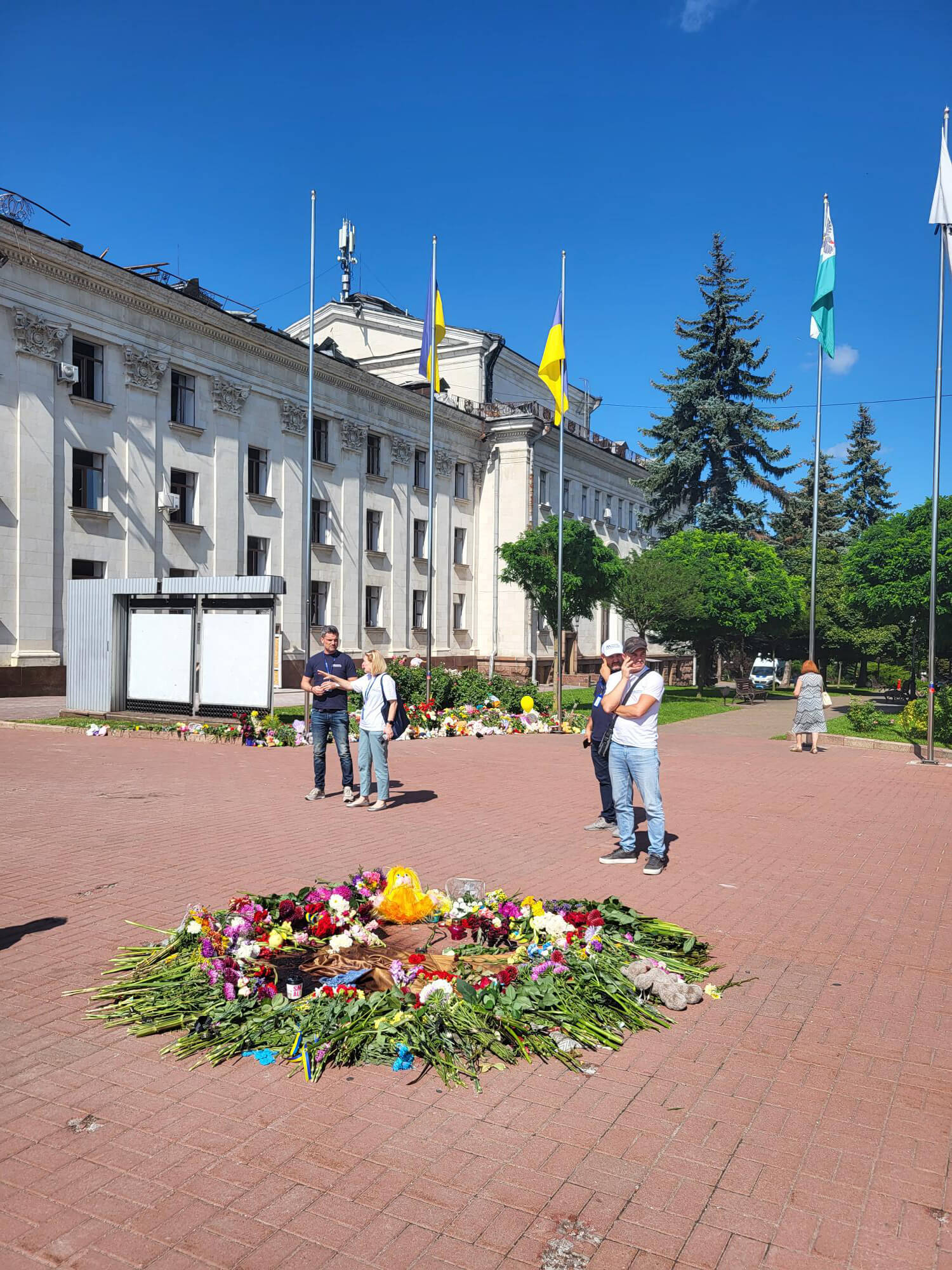 UKR_20230821_144345-2 Our staff stand in front of a memorial spontaneously created by community members for victims of the attack.