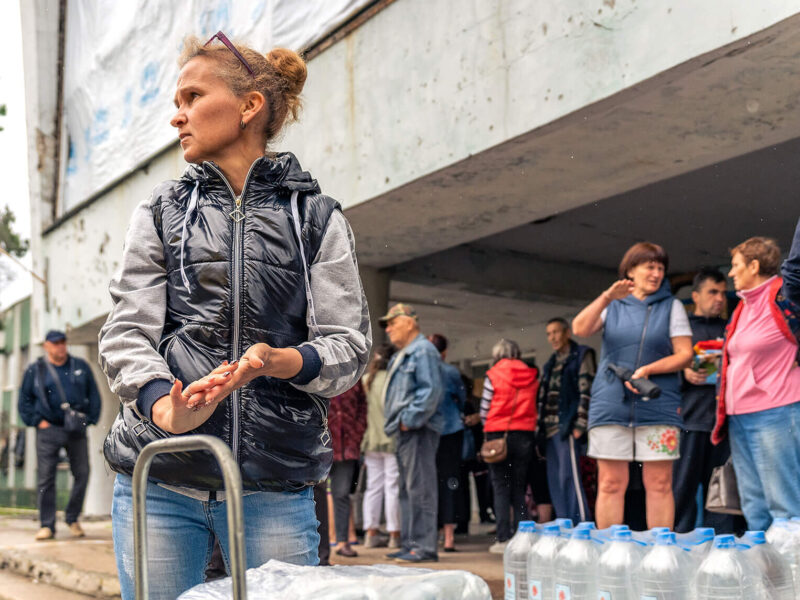 A woman in Novovoronsovka village receives clean water and supplies from International Medical Corps.