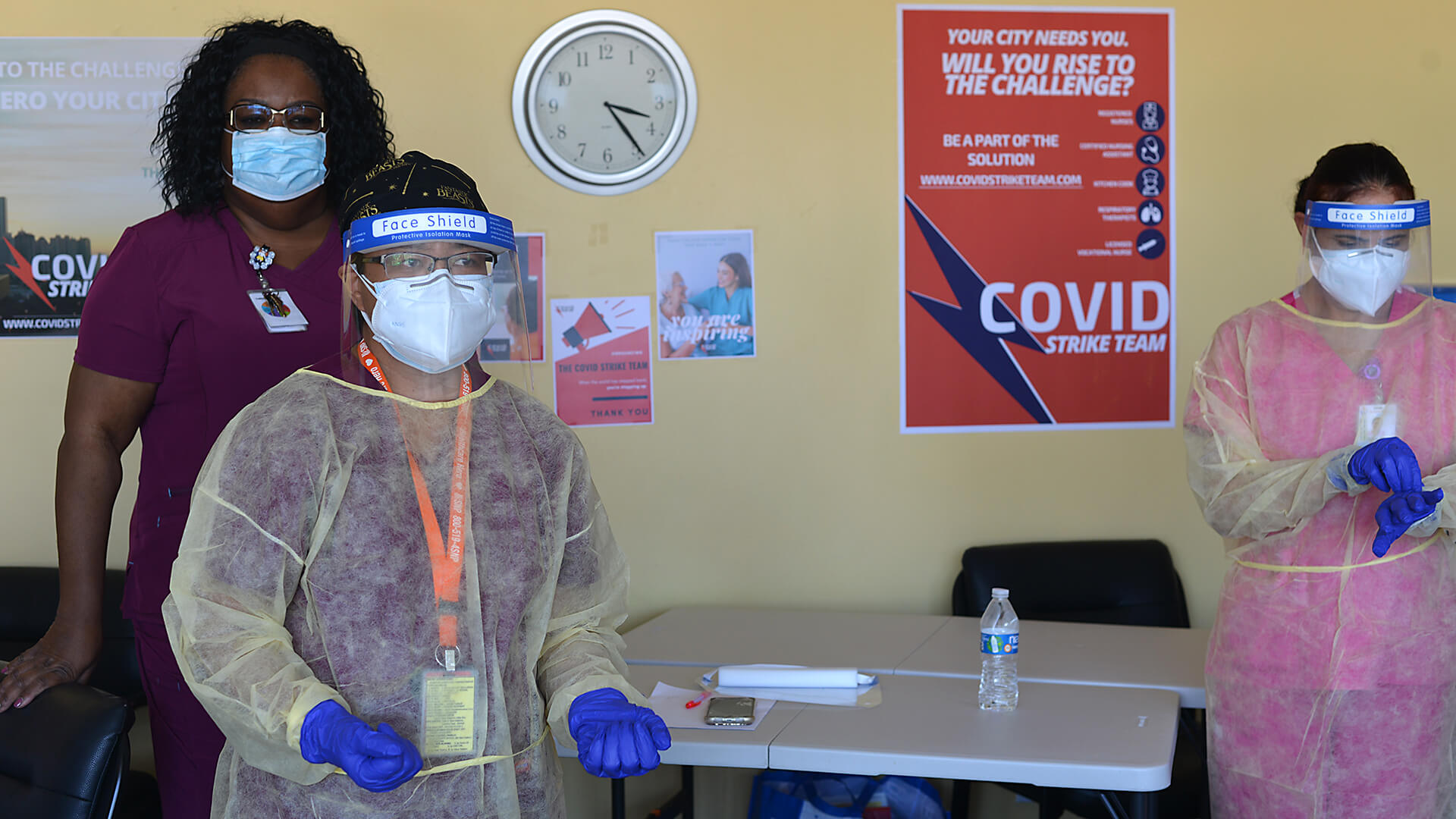 US_04_DSC_3364 Monica Washington ties a gown for Celia Lagay during a demonstration of how to properly do personal protective equipment (PPE) to prevent against COVID-19 at the Eastland Subacute and Rehabilitation Center in El Monte, California.