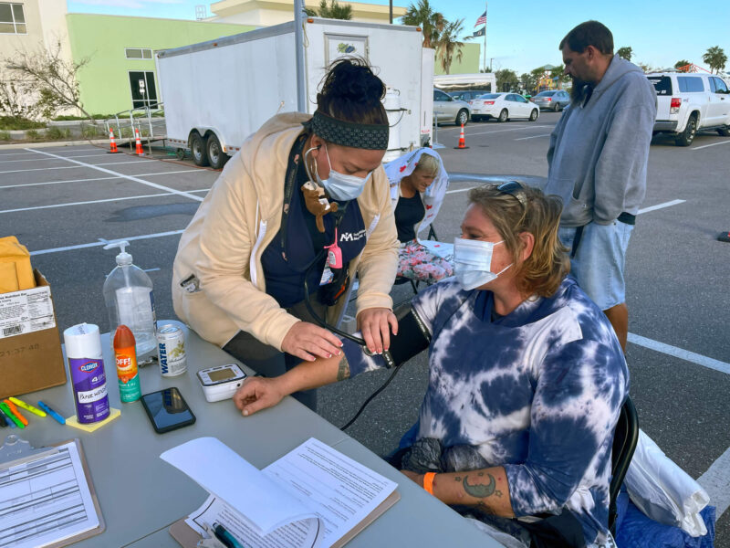 MediSys nurse Laurie Regan takes a patient's blood pressure.