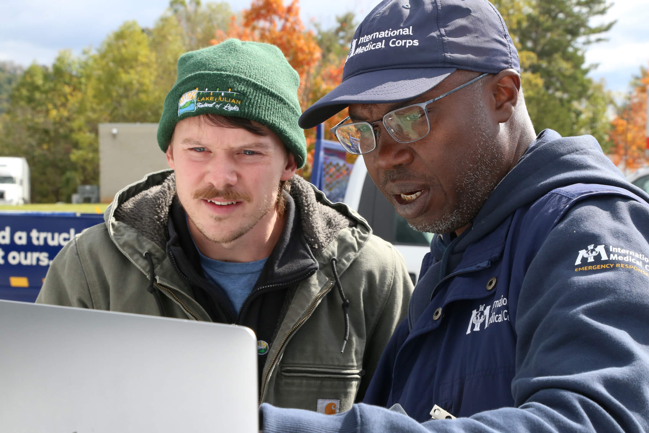 Assim works with a local driver to plan an alternate route to deliver a water tank to a federally qualified health facility (FQHC) in Buncombe County.
