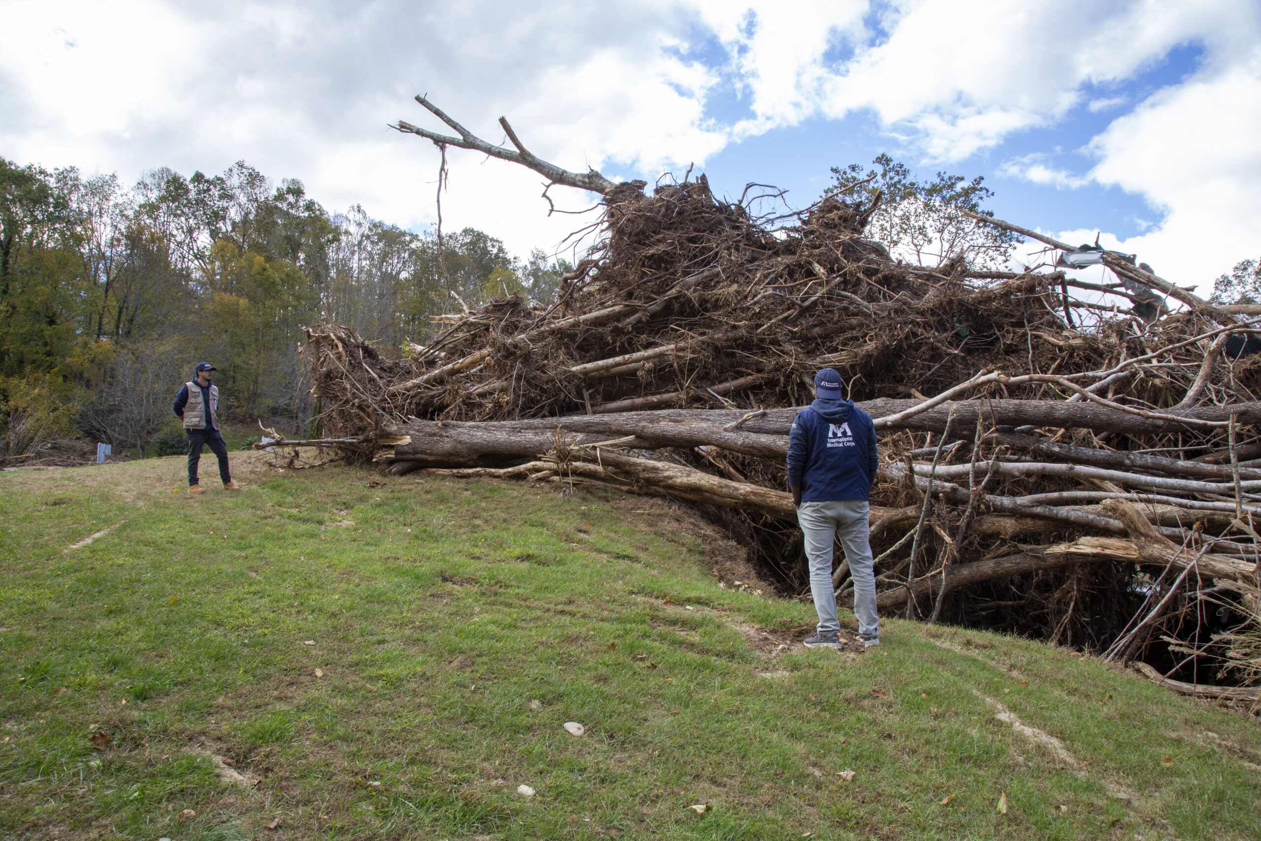 Staff members Assim Salih and Adrian Rivera survey damage in Buncombe County.