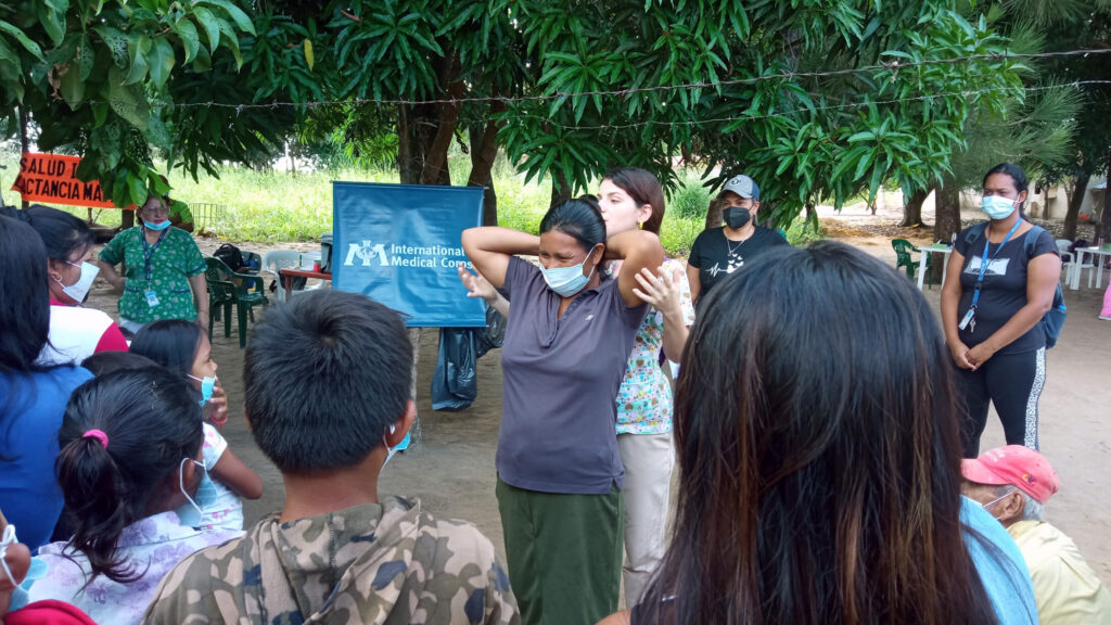 Dr. Karla Muñoz, Sexual and Reproductive Health Specialist, teaches breast self-examination techniques to the indigenous community of Villanueva in Maripa during an MMU deployment.