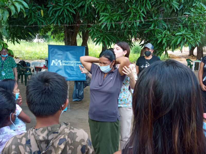 Dr. Karla Muñoz, Sexual and Reproductive Health Specialist, teaches breast self-examination techniques to the indigenous community of Villanueva in Maripa during an MMU deployment.