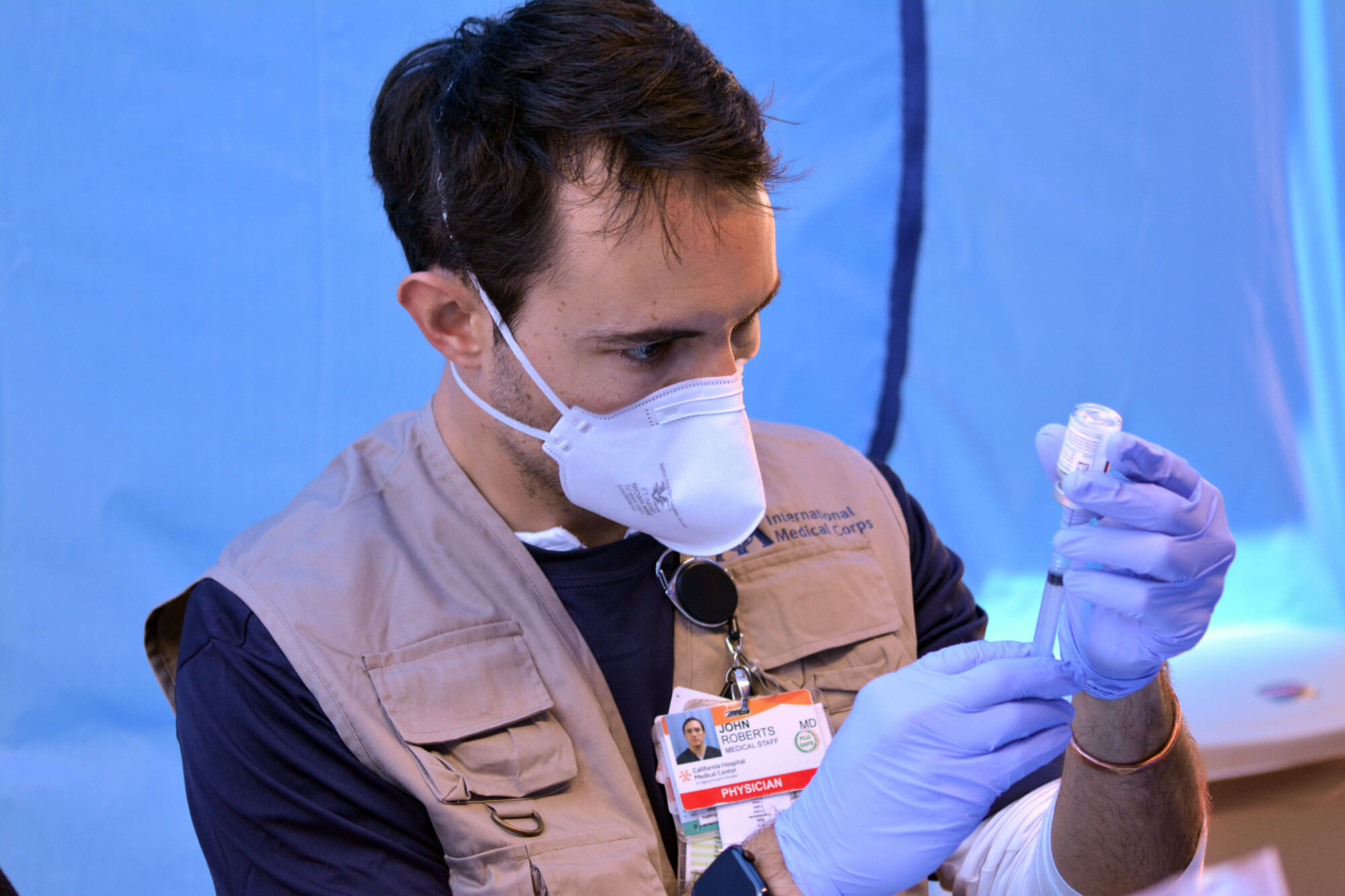 Dr. John Roberts prepares a COVID-19 vaccine dose at Kedren Community Health Center in South Los Angeles.