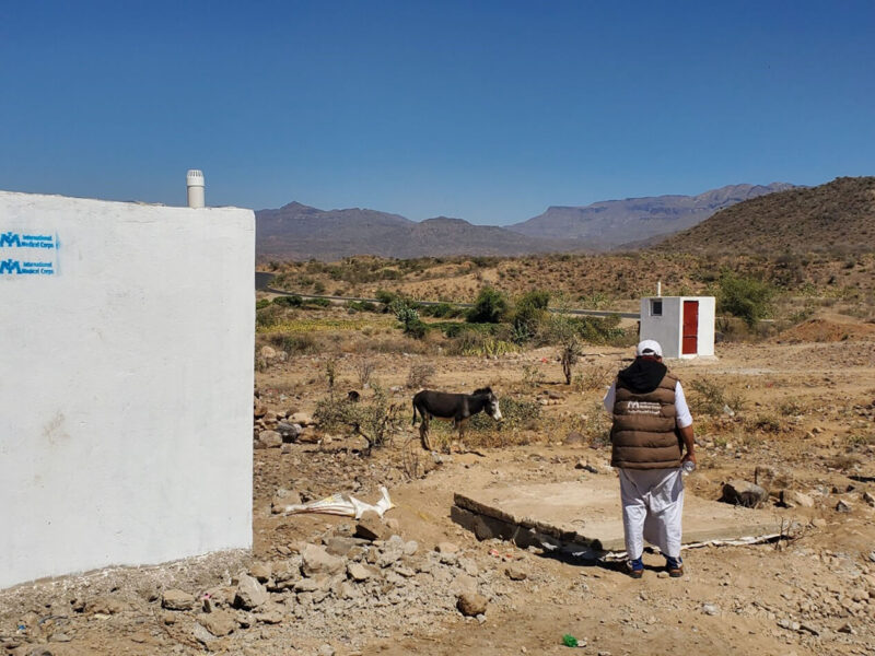 Amer Mohammed, Senior WASH Engineer, surveys the latrine project at Al-Barza IDP camp in Yemen.