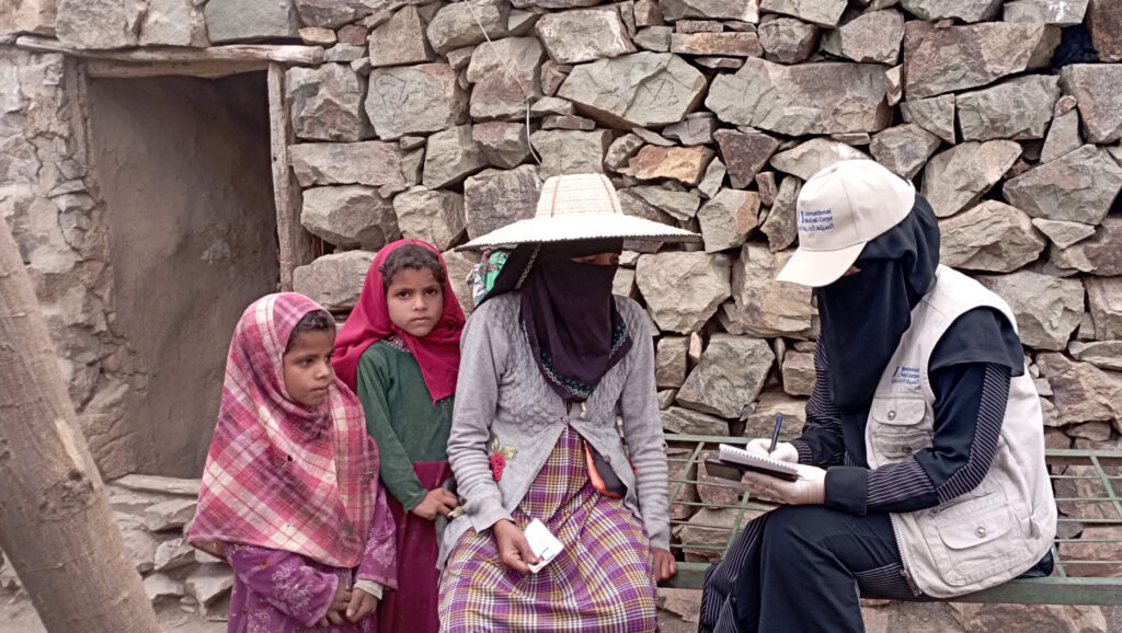 During an outreach and awareness-raising activity, an International Medical Corps community health worker (CHW) informs women about the cash assistance program.