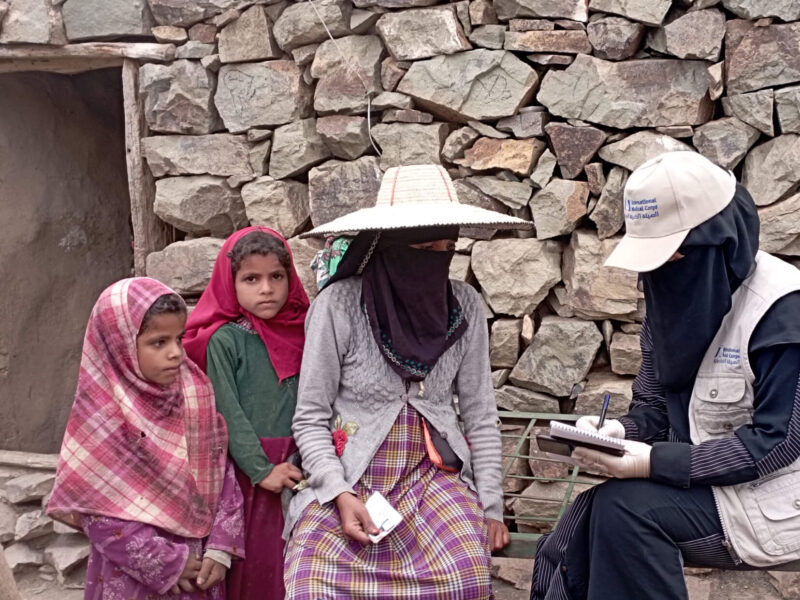 During an outreach and awareness-raising activity, an International Medical Corps community health worker (CHW) informs women about the cash assistance program.