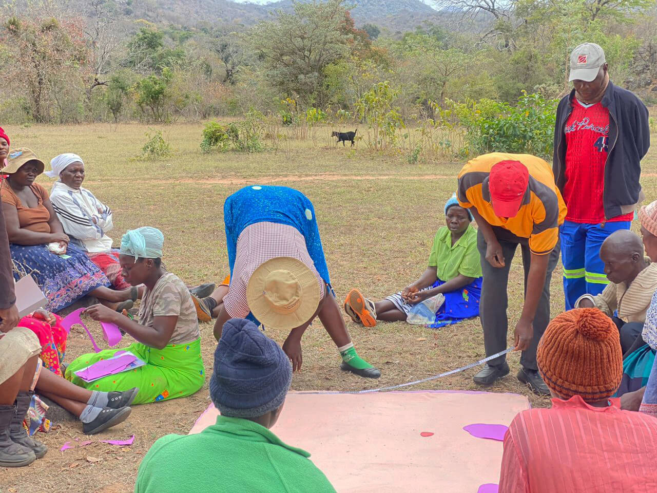 ZIM_CHC-members-cutting-fabric-during-RUMP-making-training-at-club-level Community health workers cut fabric.