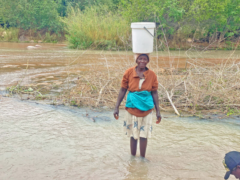 “Water is life, but this water brings sickness,” says Susan Matotote, returning from the Dewure River with contaminated water.