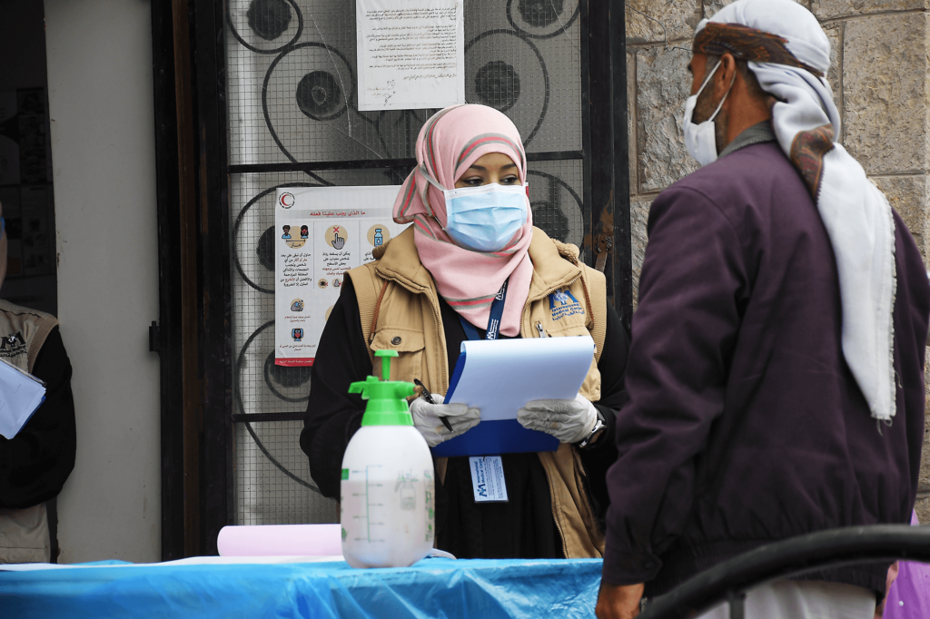 International Medical Corps Health Program Manager Dr. Nebras Khaled interviews a patient at a mobile clinic in Sana’a Governorate.